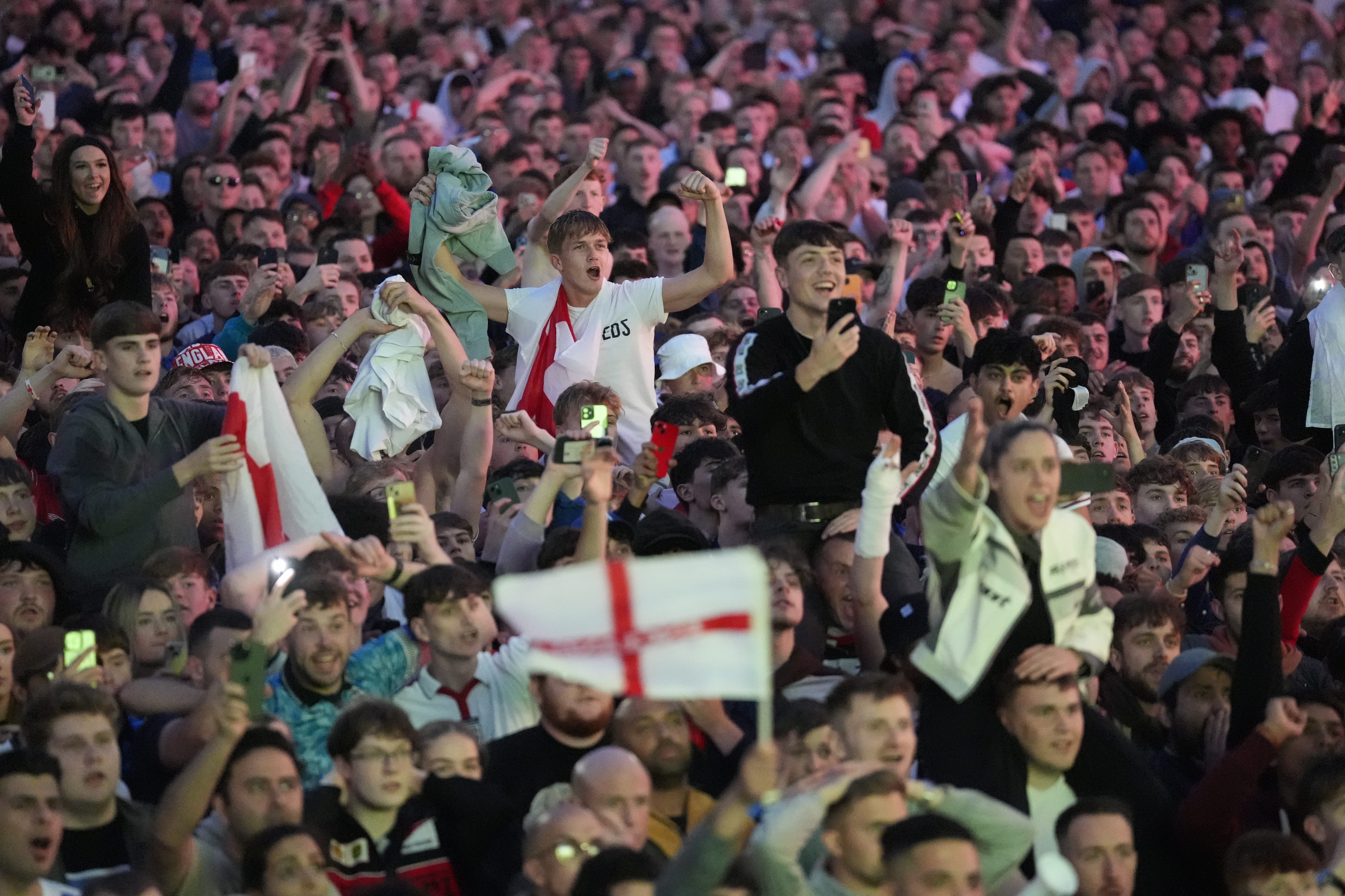 England fans at Millennium Square in Leeds celebrate after the team’s win in the Euro 2024 semi-final (Danny Lawson/PA)