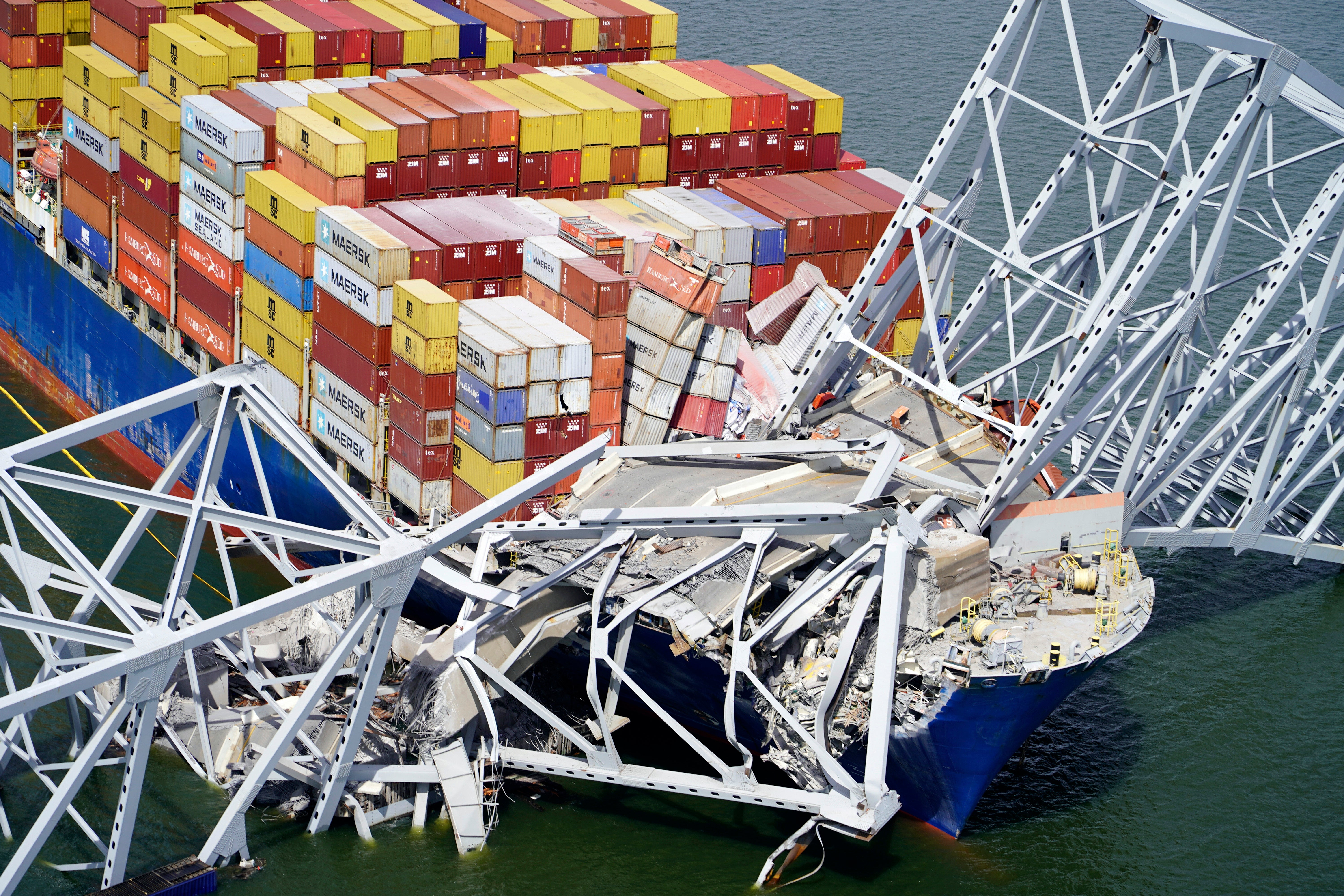 The cargo ship Dali is stuck under part of the structure of the Francis Scott Key Bridge after the ship hit the bridge, Tuesday, March 26, 2024, in Baltimore