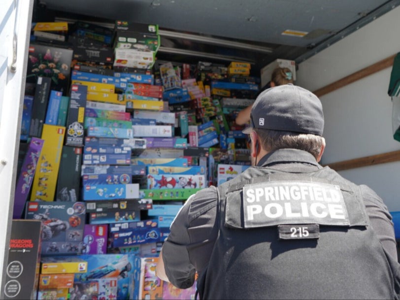 A police officer in Eugene, Oregon, stares at a container filled with Lego sets, which police allege were stolen then sold to a local toy store called Brick Builders.