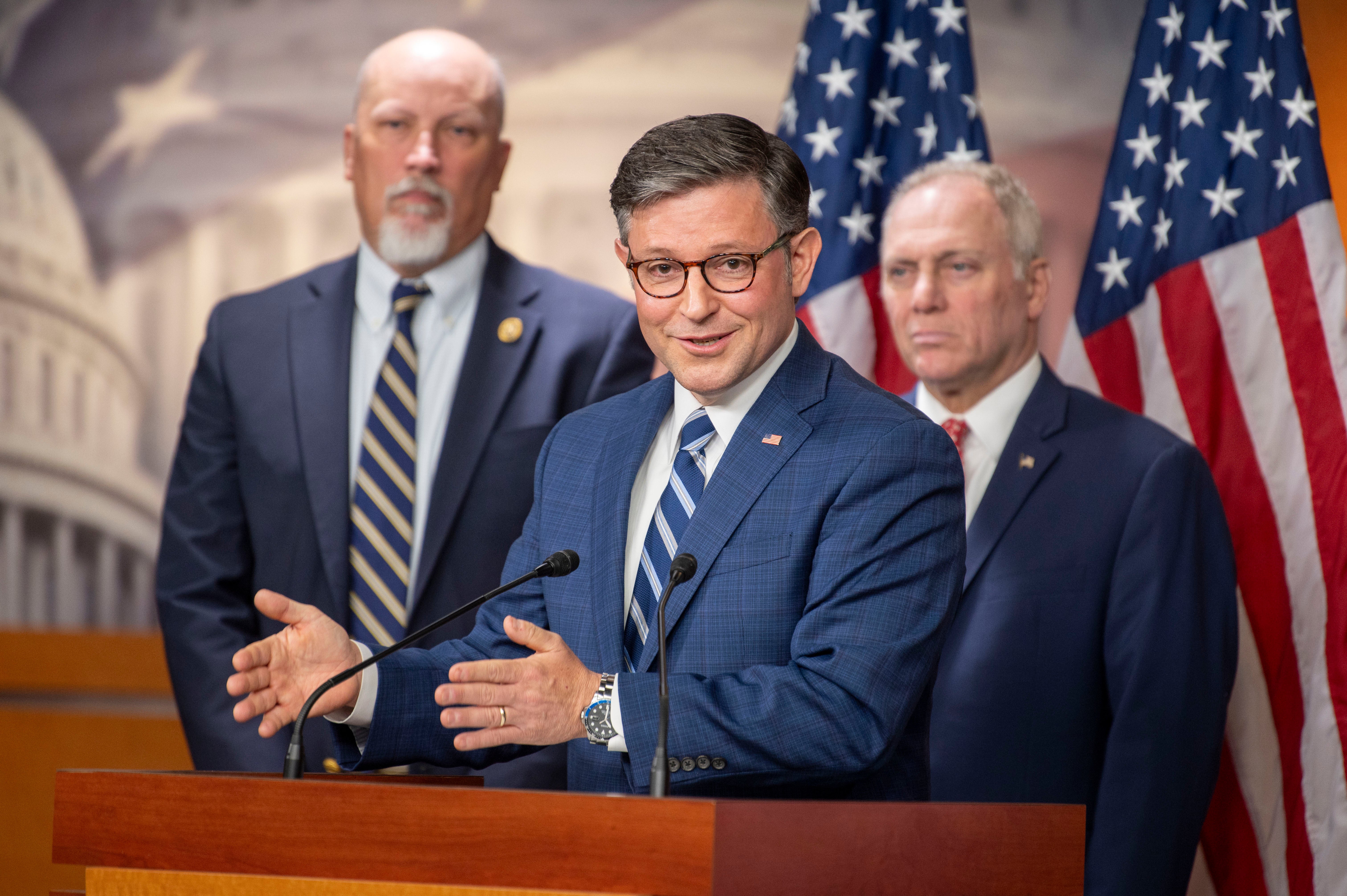 Chip Roy, left, stands behind Speaker Mike Johnson, center, at a press conference on the Hill. Roy said Tuesday that he is unsure whether to support Johnson’s re-election to the speakership for the upcoming term.