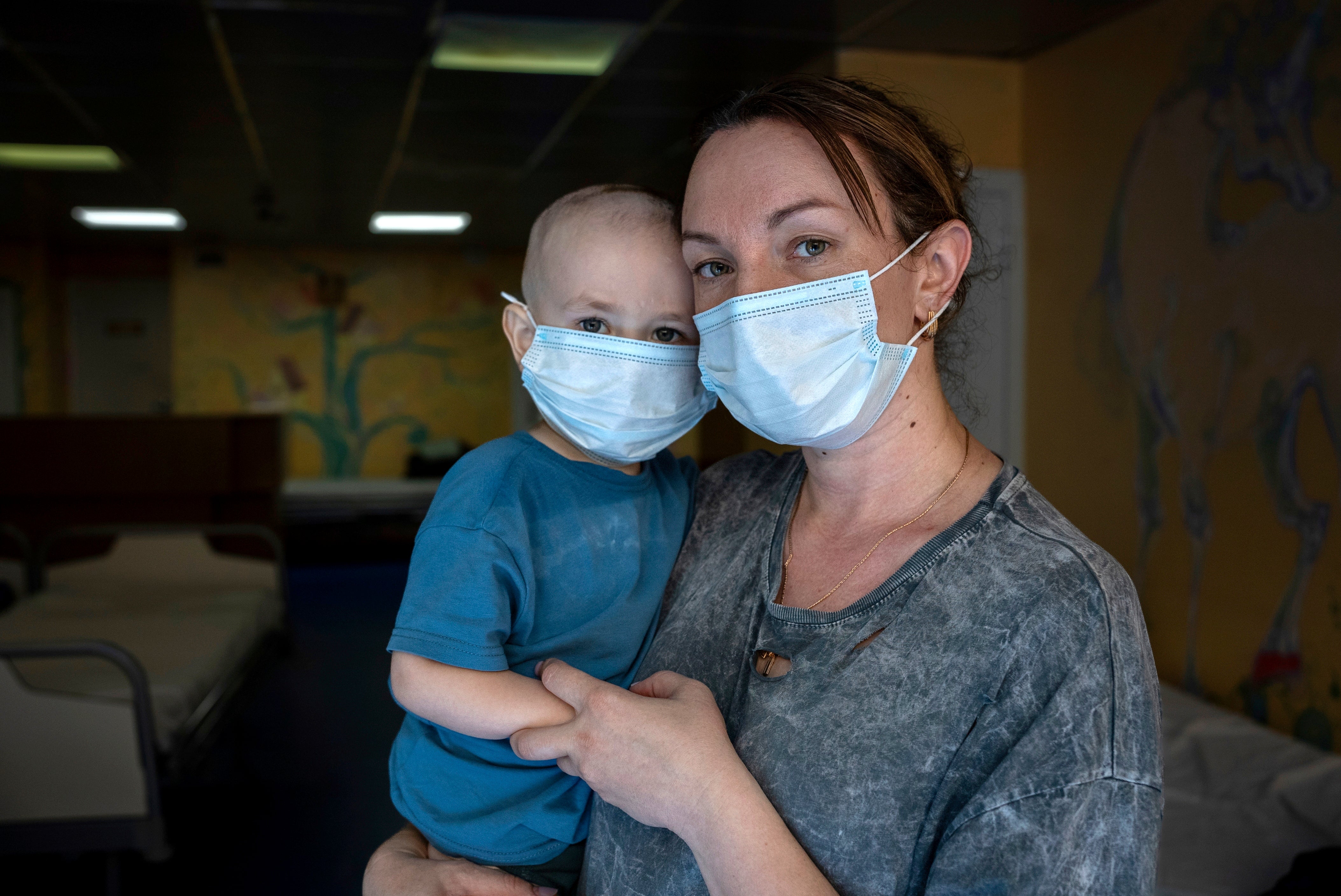 Oksana Halak poses for a portrait with her son Dmytro, two, at the National Cancer Institute in Kyiv, Ukraine