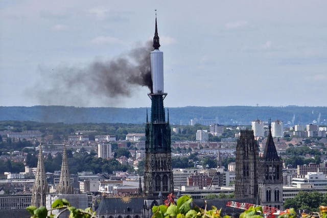 <p>Smoke billows from the spire of Rouen cathedral</p>