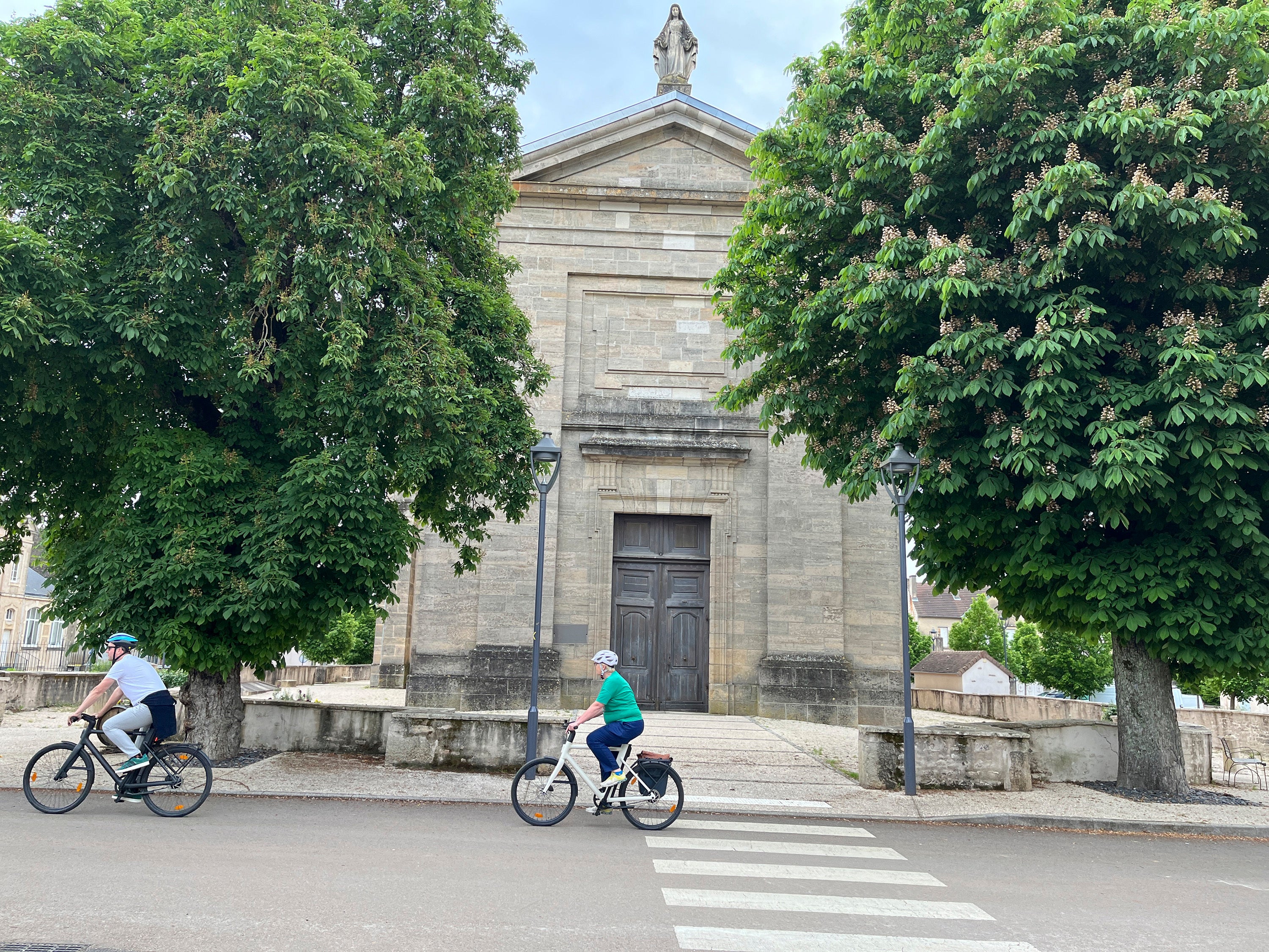 Cyclists ride through the village of Pommard in the Burgundy region of France