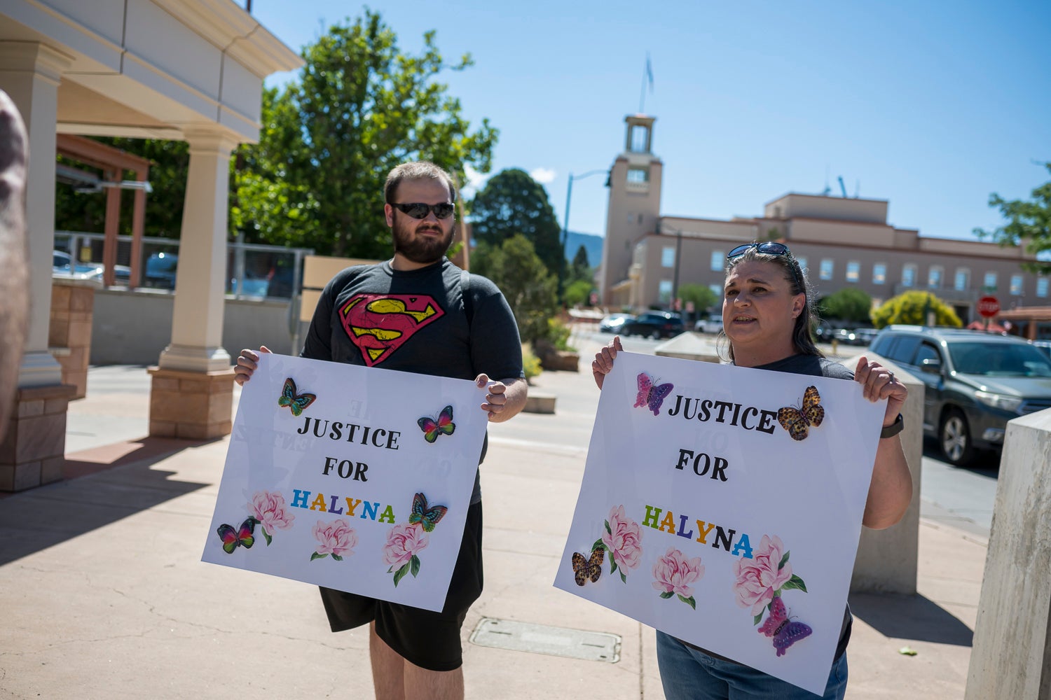 Jonathan Zwiebel, left, and his mother Janelle Rogers stand outside District Court demanding justice for cinematographer Halyna Hutchins