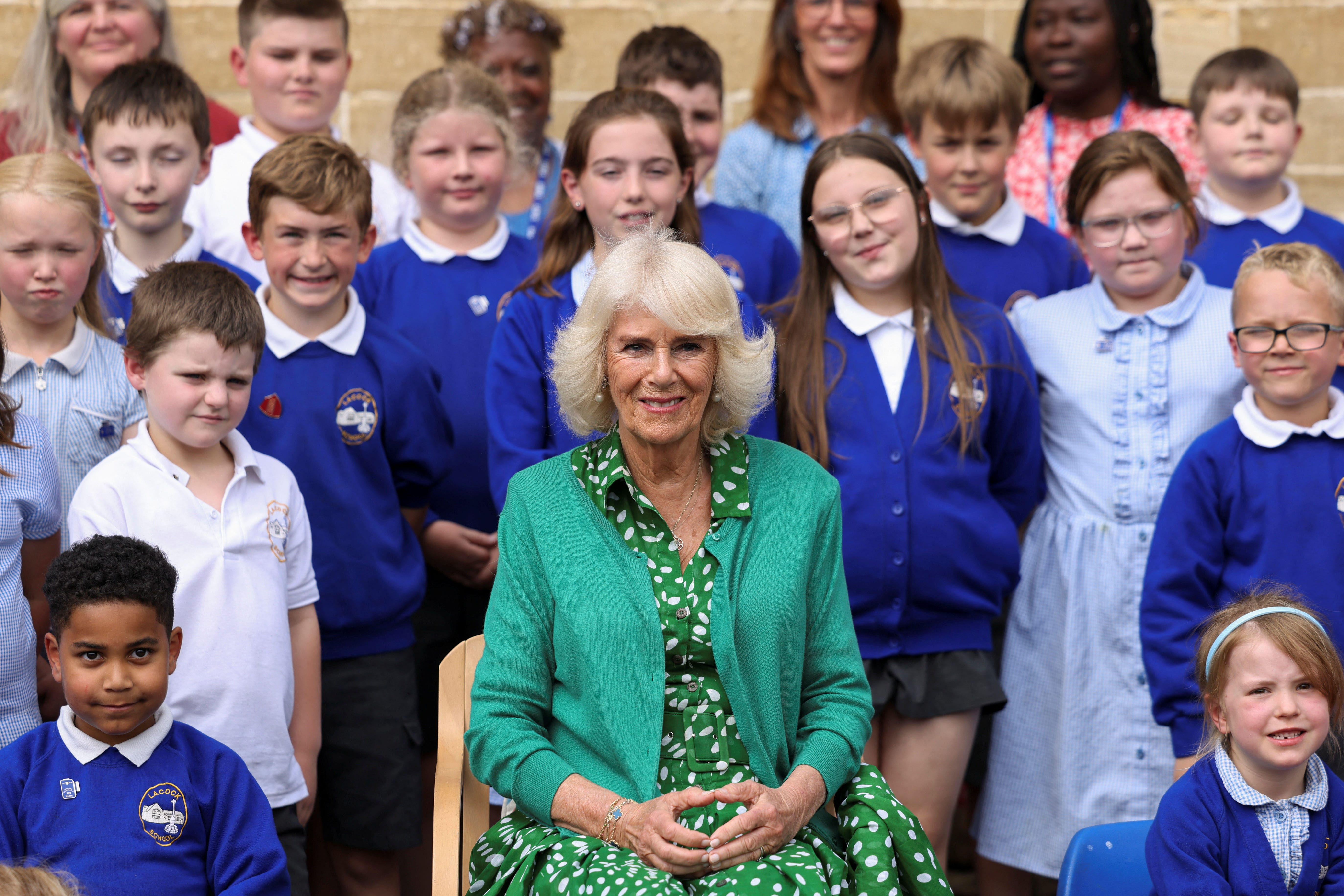 Queen Camilla poses for a photo with pupils during a visit to Lacock Church of England Primary School in Chippenham, Wiltshire (Hollie Adams/PA)