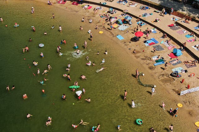 <p>An aerial view of people refreshing and sunbathing on a lake due to high temperatures in Krakow, Poland on July 10, 2024</p>