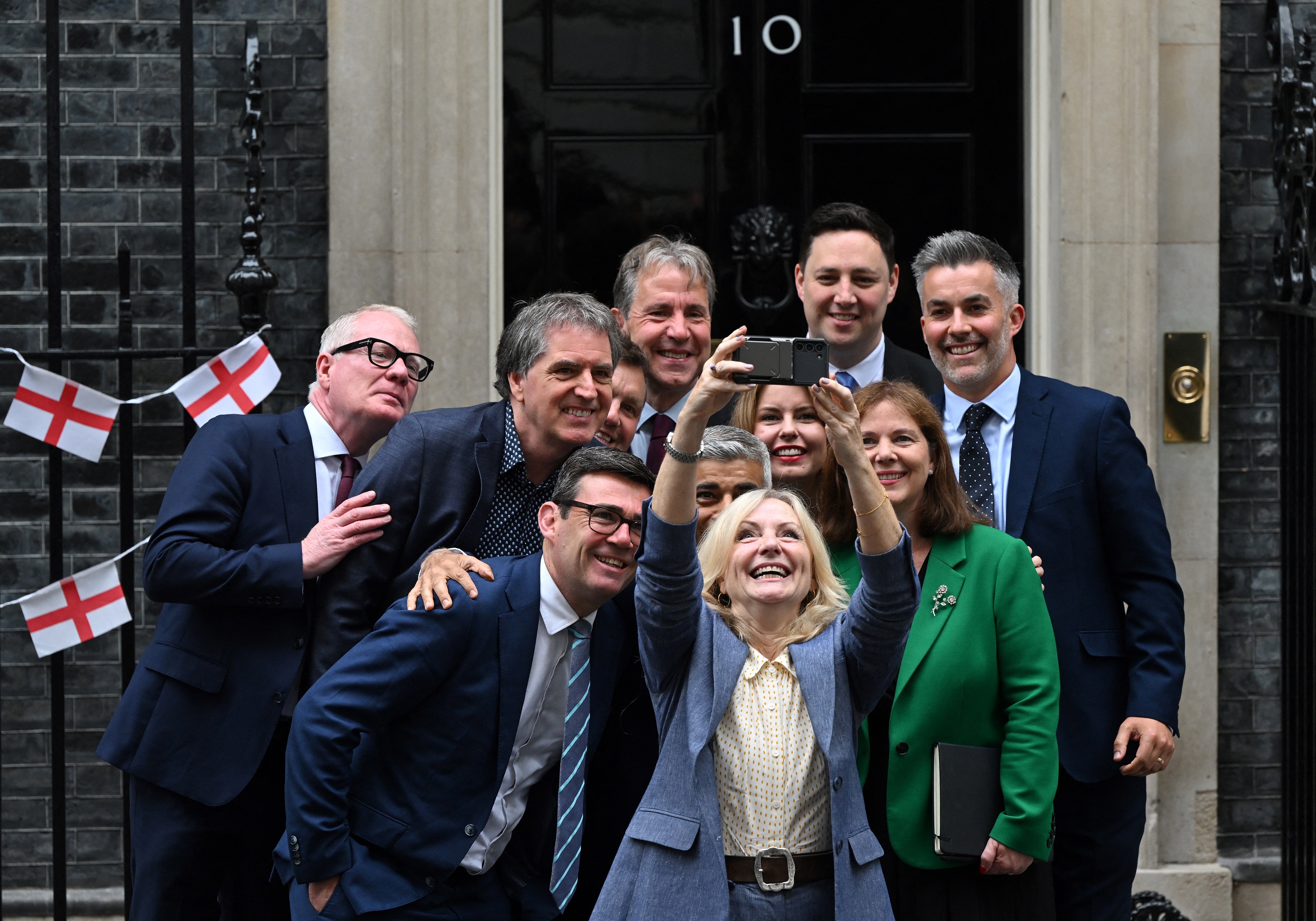 Richard Parker, Steve Rotheram, Andy Burnham, Nik Johnson, Dan Norris, Sadiq Khan, Tracy Brabin, Kim McGuinness, Ben Houchen, Claire Ward and David Skaith take a group selfie outside 10 Downing Street