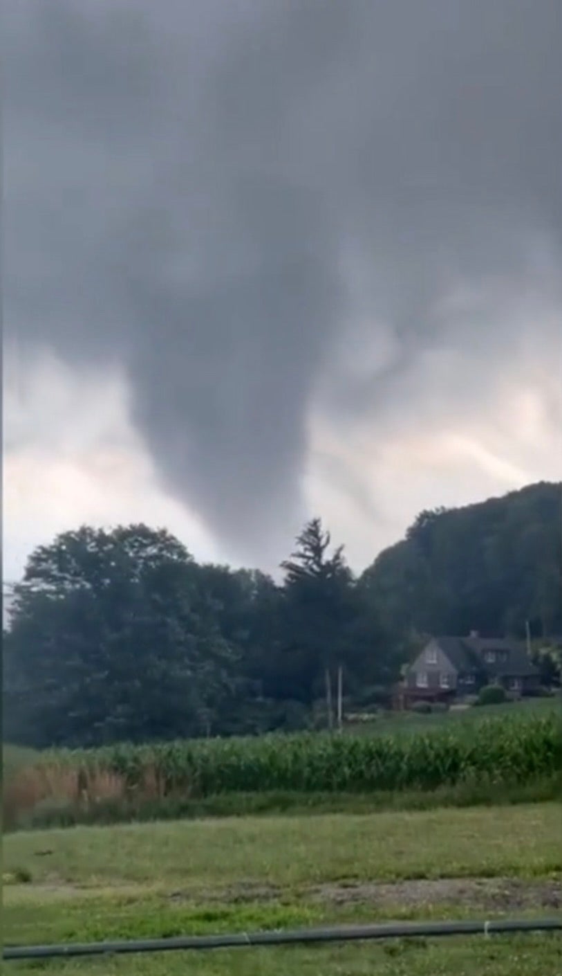 A tornado rips through fields in Eden, New York on 10 July. At least six tornadoes touched down in New York state on Wednesday as the remnants of Hurricane Beryl battered the east coast