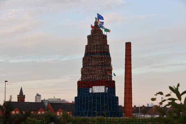 A bonfire with election posters of SDLP MP Claire Hanna and First Minister of Northern Ireland Michelle O’Neill attached to it (PA)