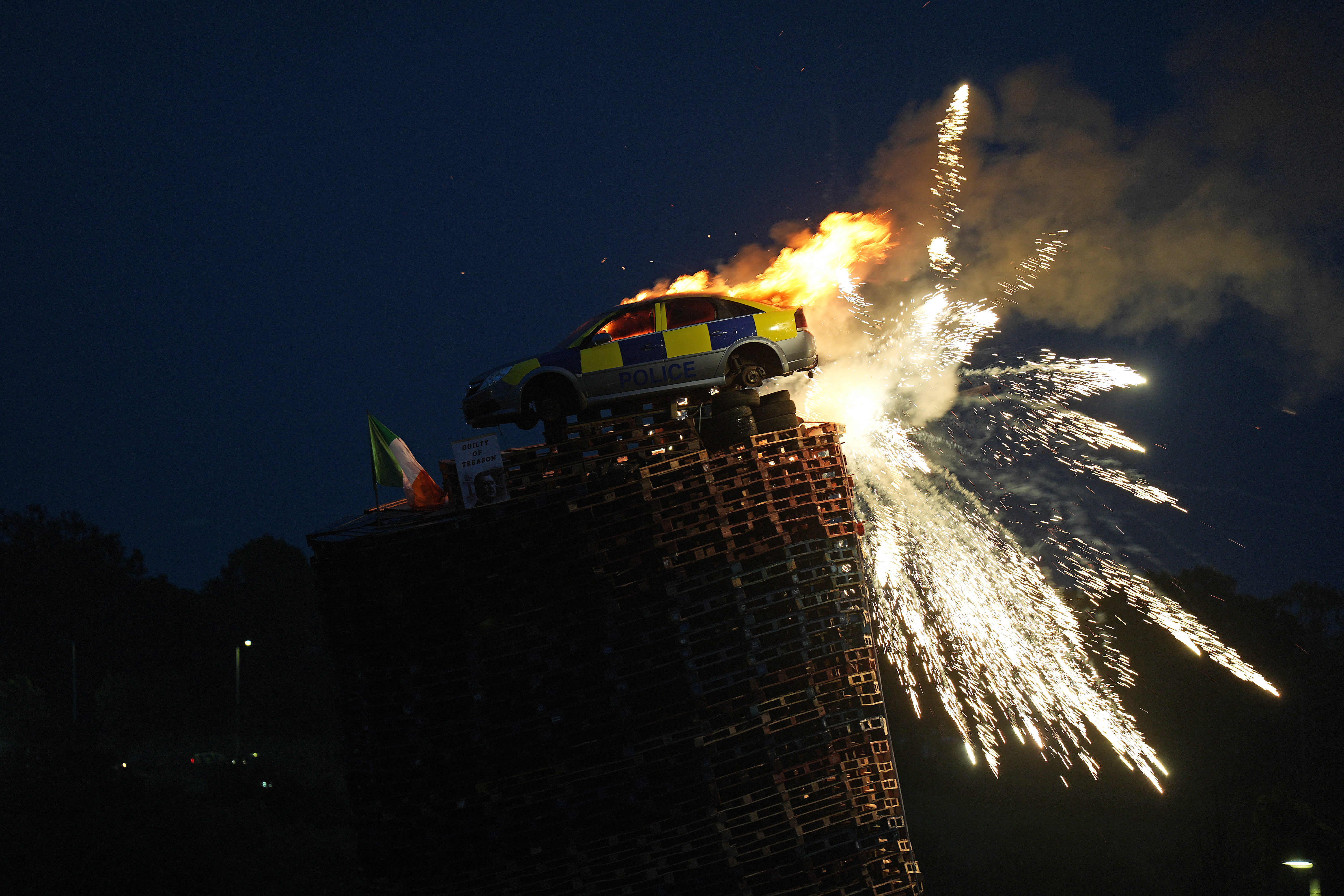 A mock police car is set alight on top of a bonfire in Moygashel near Dungannon, Co Tyrone, on Wednesday night (Niall Carson/PA)