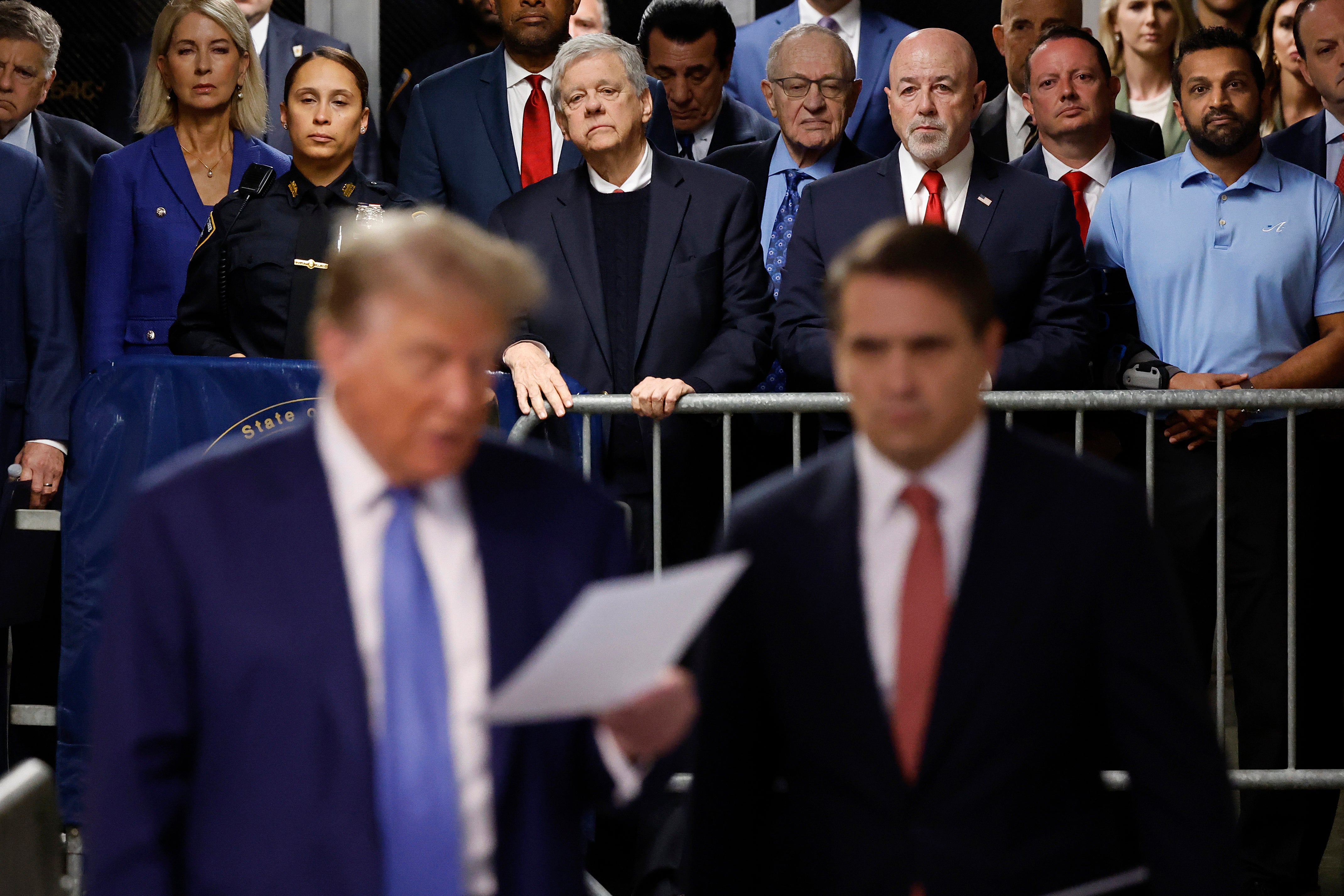 Donald Trump’s allies watch Donald Trump and his attorney Todd Blanche address reporters at his criminal trial in Manhattan on May 20.