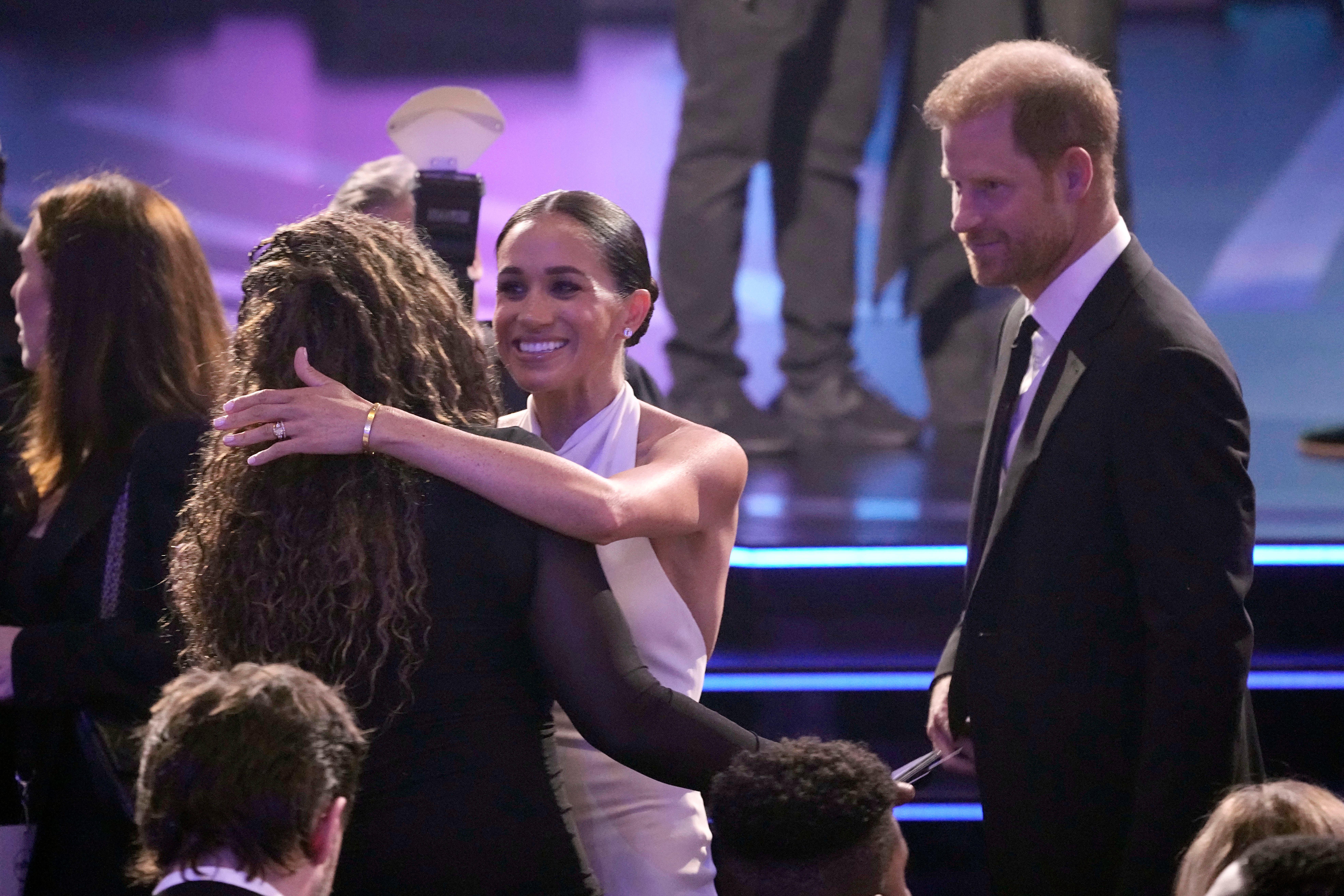Meghan Markle, centre, and Prince Harry, right, arrive at the ESPY awards on Thursday, at the Dolby Theatre in Los Angeles (Mark J Terrill/AP)