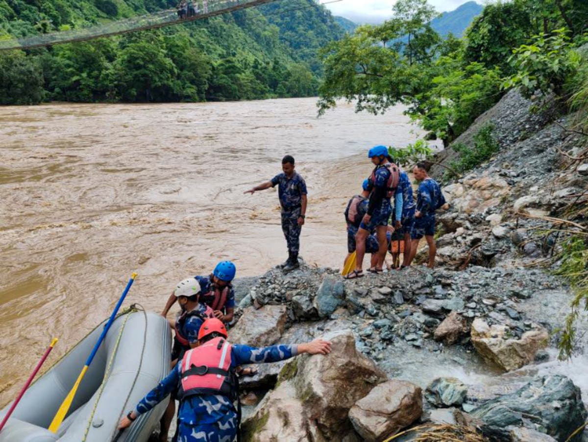 At least 60 missing in Nepal after landslides sweeps buses into swollen river