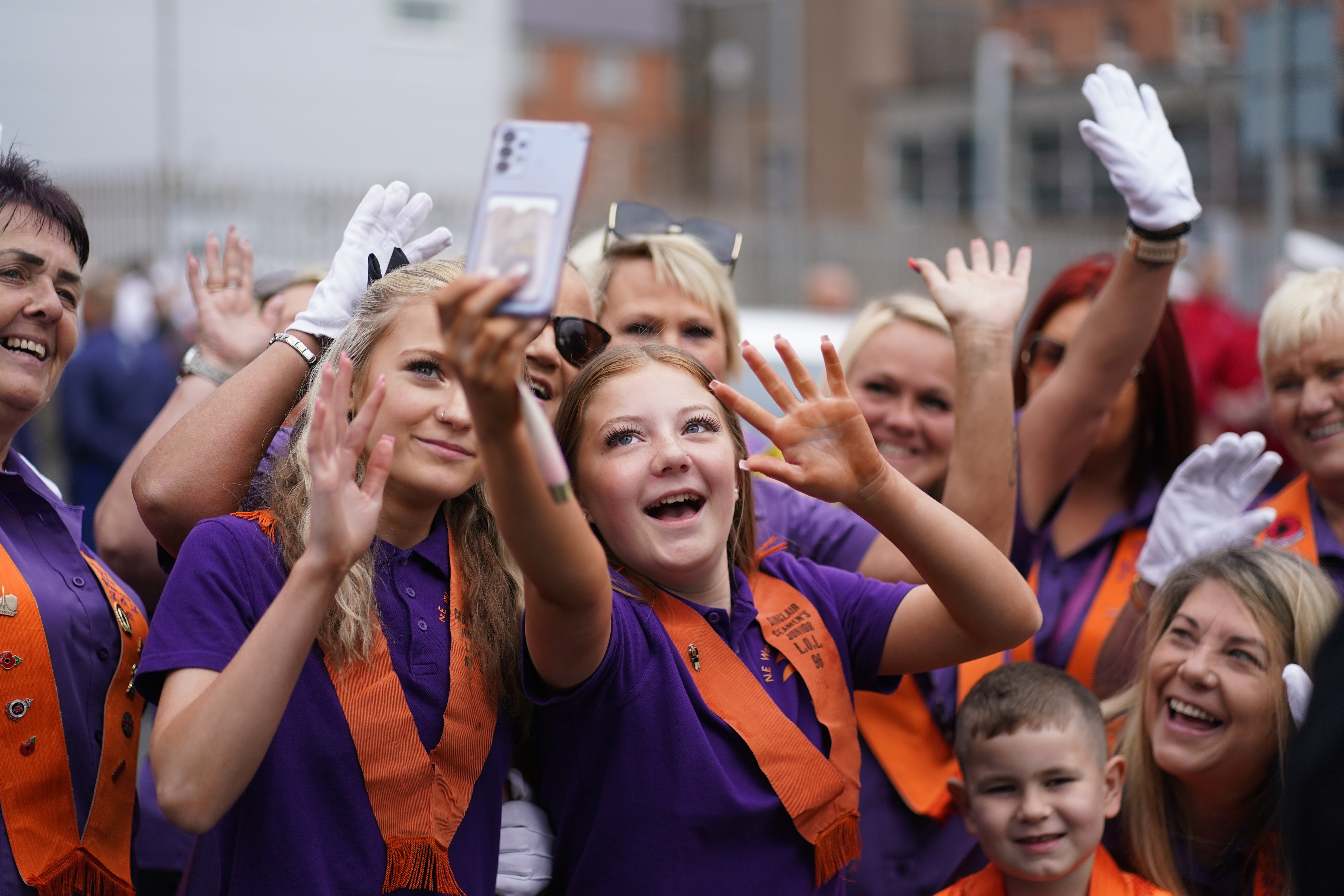 People gather at Carlisle Circus in Belfast ahead of an Orange Order parade (Brian Lawless/PA)