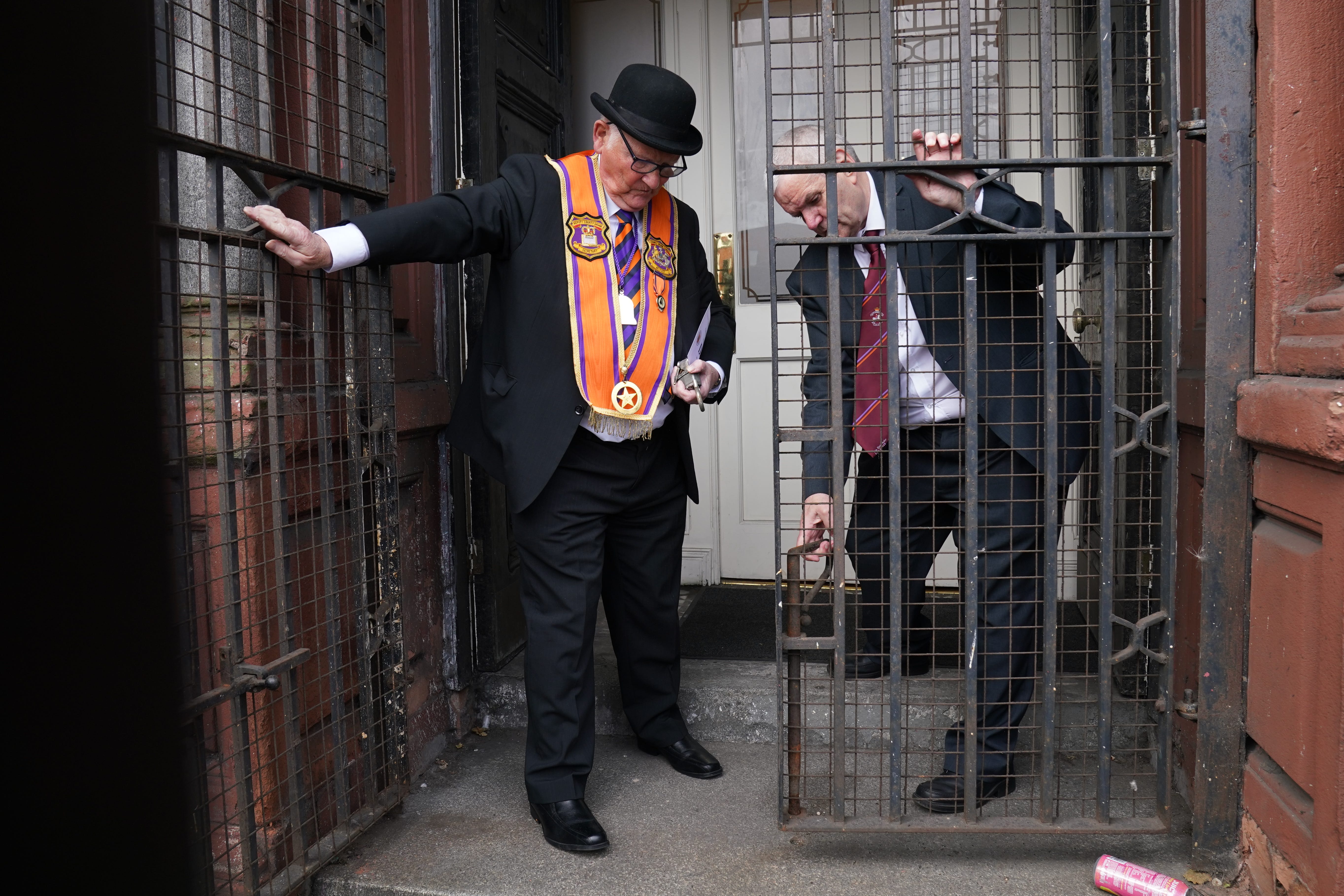 Orange Order members open the gates to the Belfast Orange Hall on Clifton Street in Belfast ahead of their parade (Brian Lawless/PA)