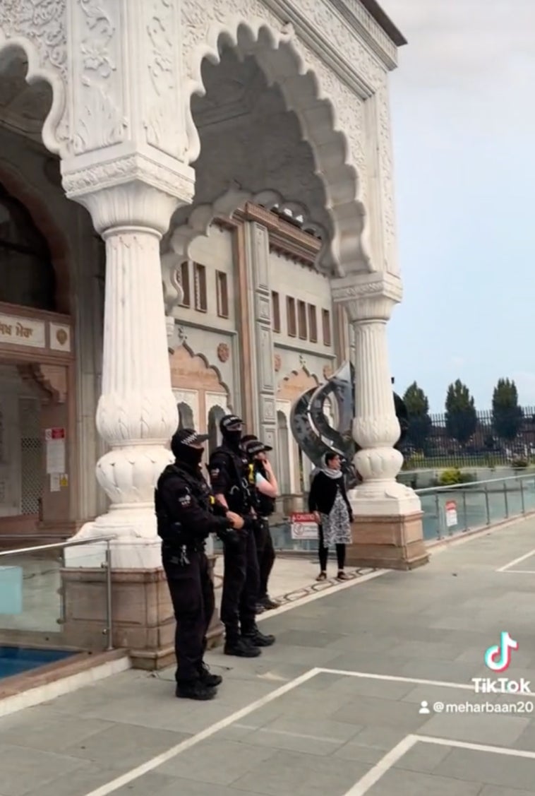 Armed police guard the entrance to the gurdwara