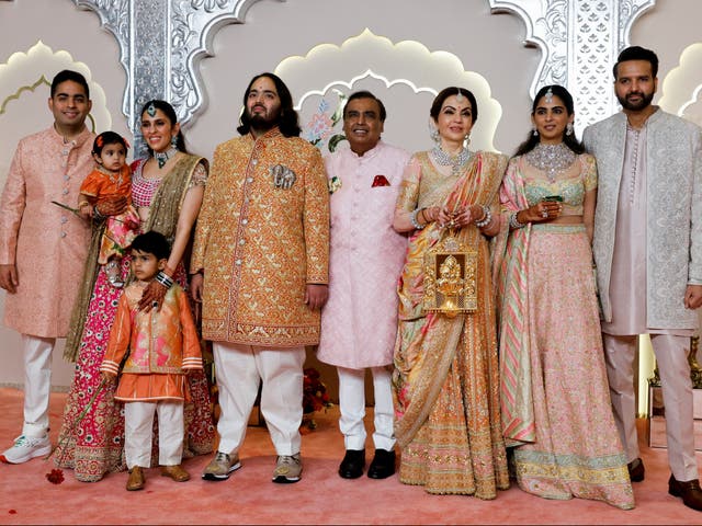 <p>Groom Anant Ambani (wearing an elephant motif) with his brother Akash Ambani (L), sister-in-law Shloka Mehta, father Mukesh Ambani (centre), sister Isha Ambani, and brother-in-law Anand Piramal on the red carpet on Friday</p>