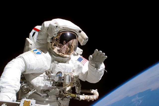<p>American astronaut Joseph Tanner on a space walk at the International Space Station in September 2006</p>