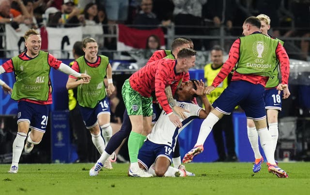 Ollie Watkins, centre, celebrates his crucial goal with Dean Henderson and the England substitutes (Nick Potts/PA)