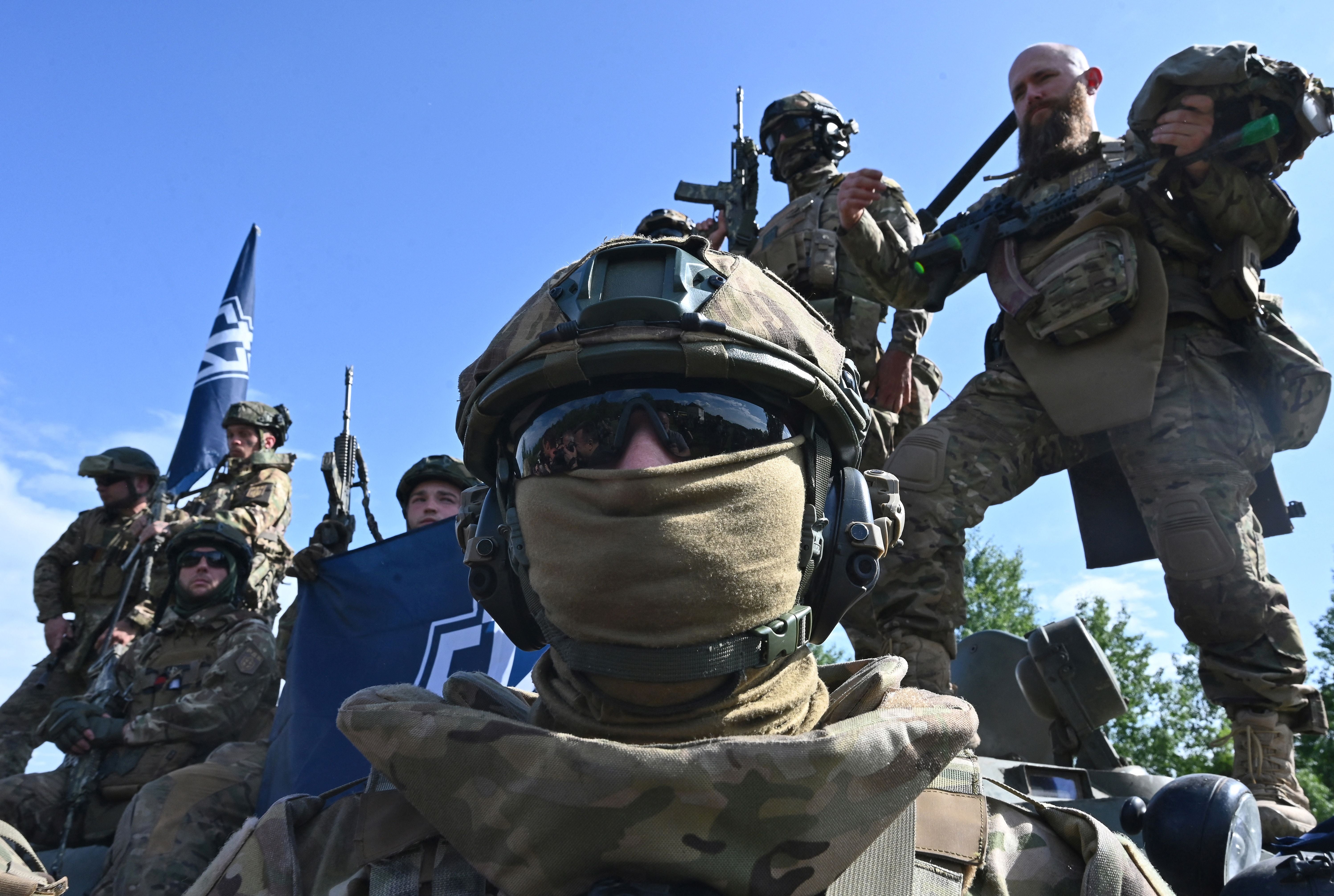 Fighters of the Russian Volunteer Corps attend a presentation for the media in northern Ukraine, not far from the Russian border, on May 24, 2023