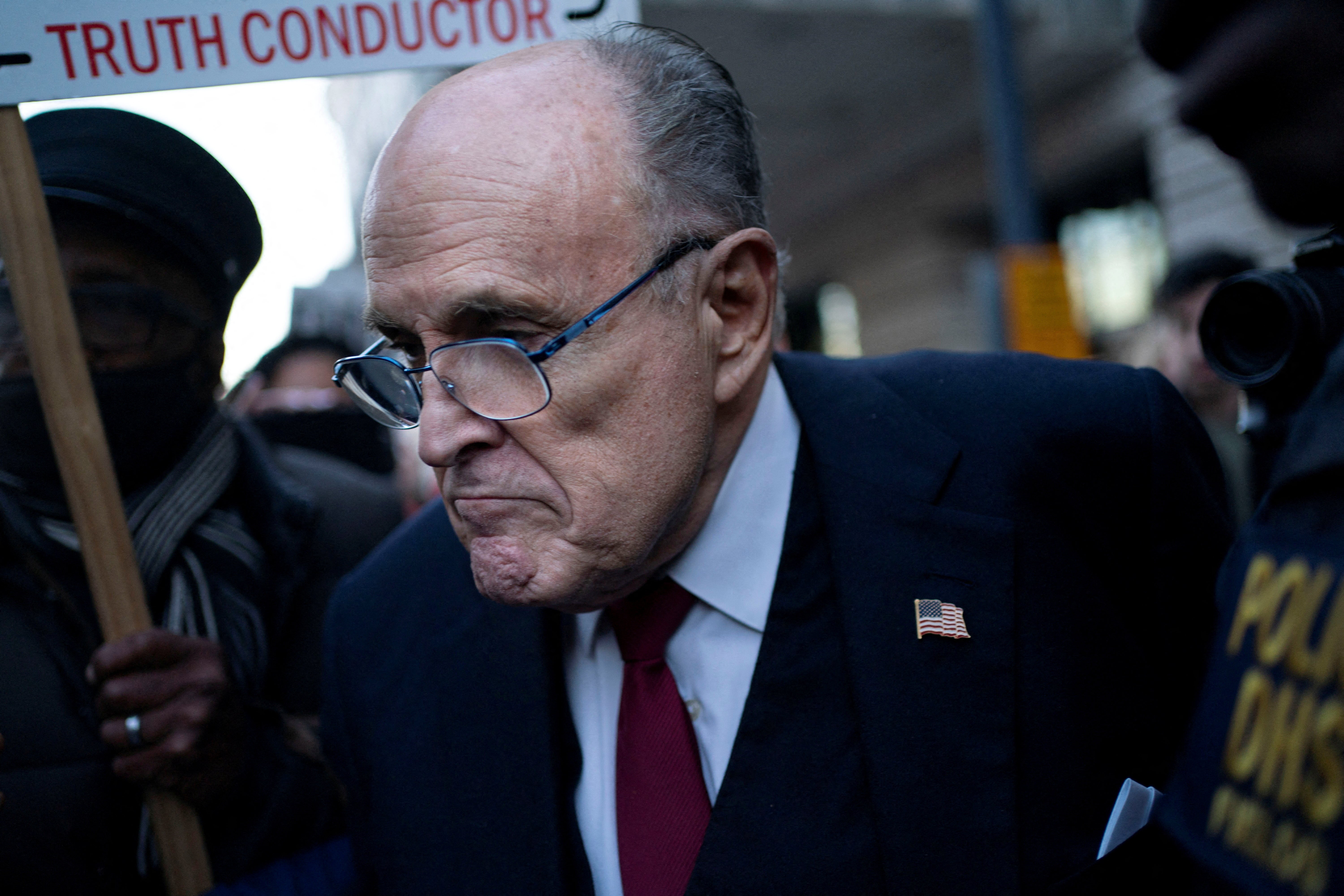 Rudy Giuliani is pictured leaving a federal courthouse in December 2023 after he was ordered to pay $148 million to election workers he defamed.