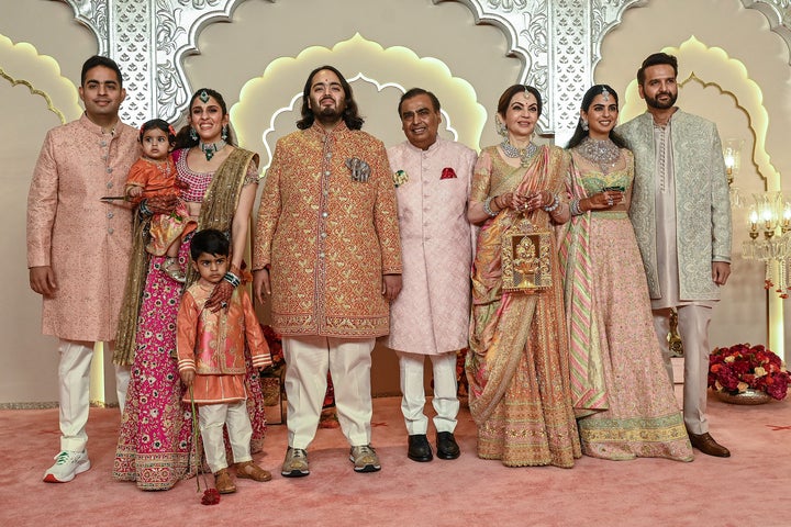 Anant Ambani poses with his family at his wedding.