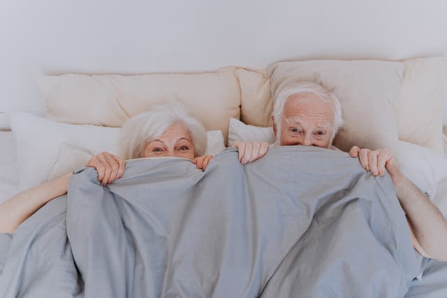 <p>An older couple enjoying some fun in bed</p>