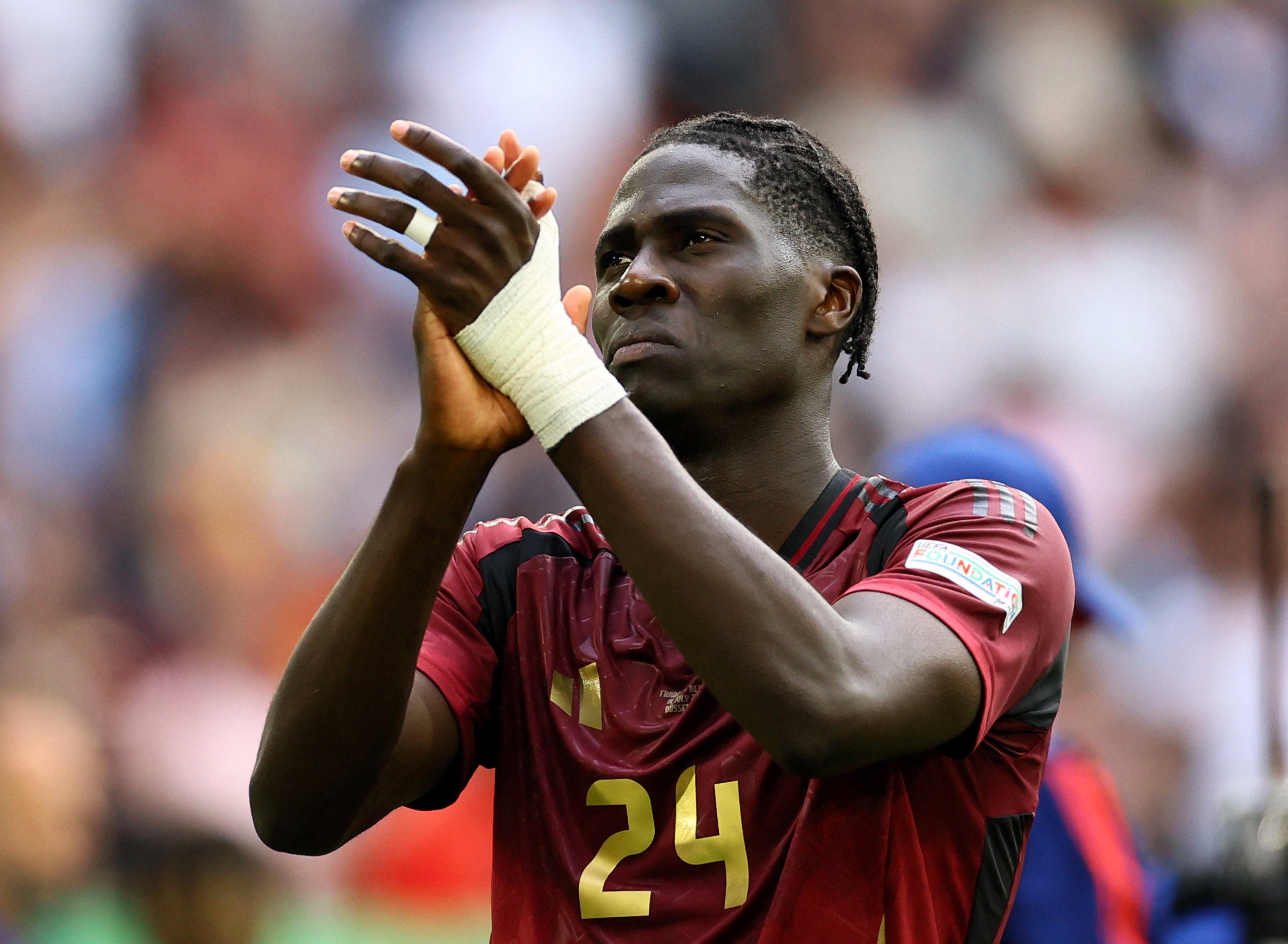 Belgium's Amadou Onana looks dejected as he applauds fans