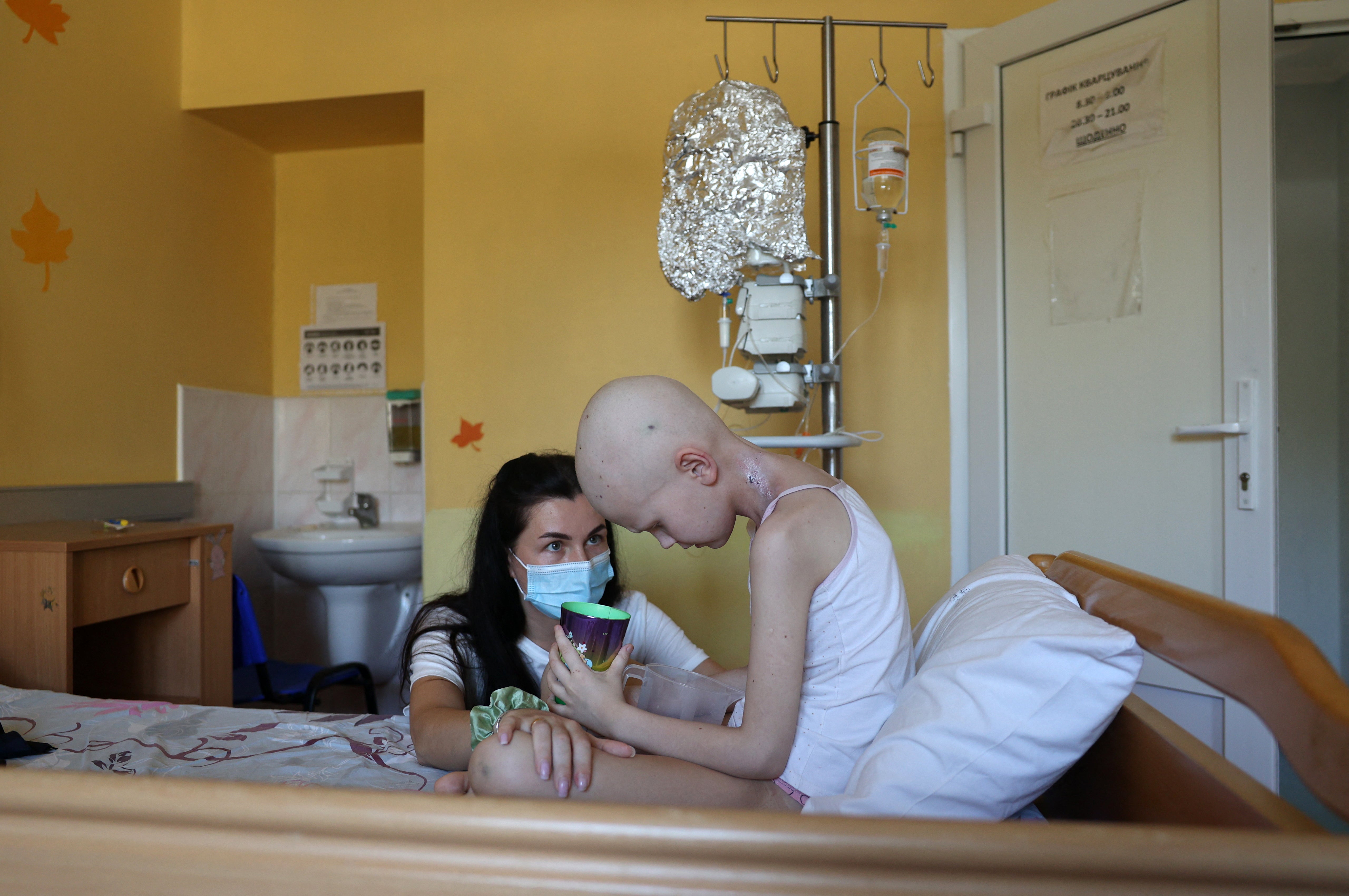 Darya Vertetska, 33, talks to her daughter Kira, 8, in the children's ward of the National Cancer Institute in Kyiv. Kira was injured by glass fragments in a Russian missile attack on the Okhmatdyt Children's Hospital on July 8 and was taken to the National Cancer Institute along with her mother.