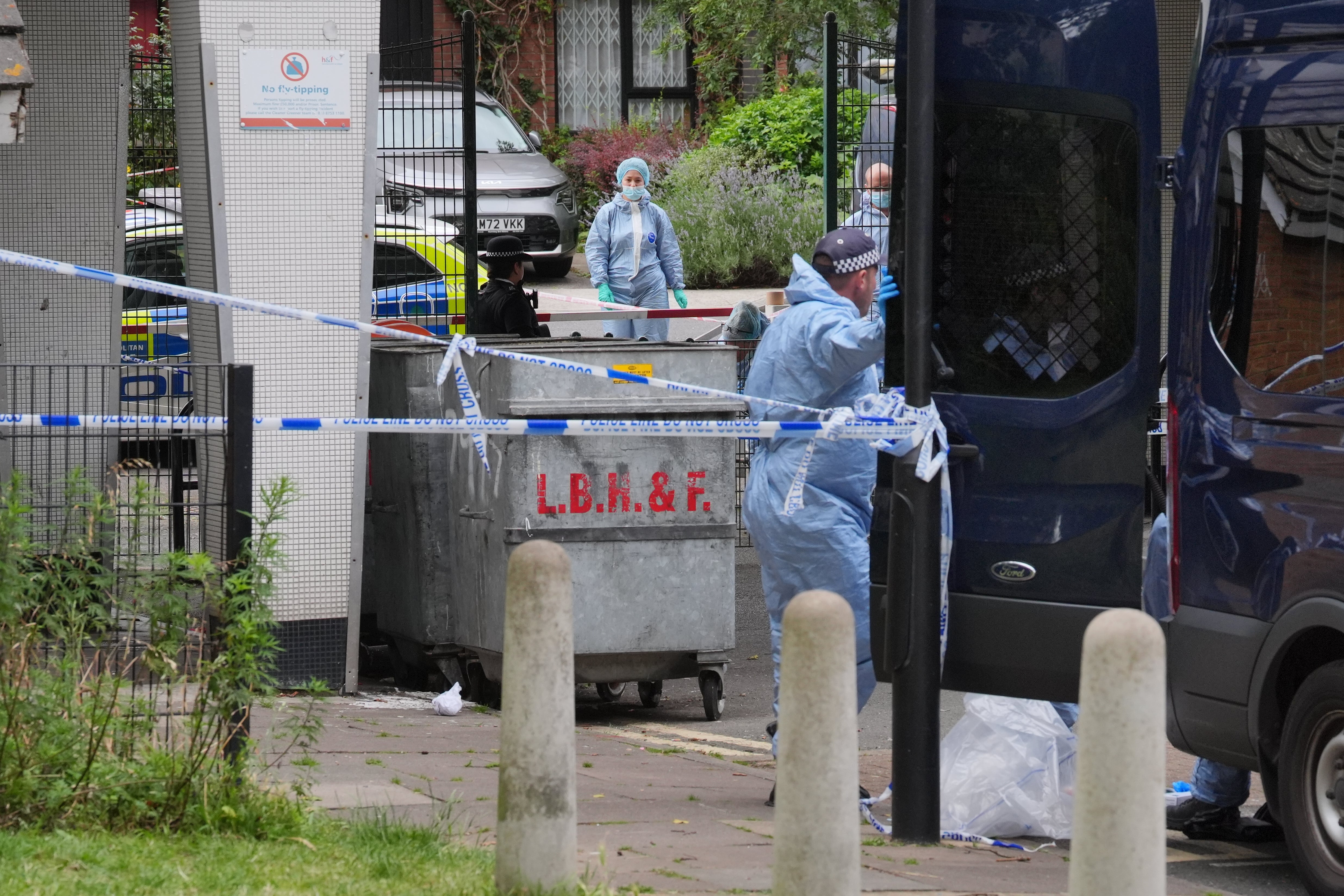 Forensic officers in Shepherd's Bush, west London on Saturday, after human remains were found in two suitcases near the Clifton Suspension Bridge in Bristol.