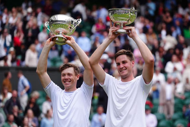 Harri Heliovaara and Henry Patten lift their trophies (Mike Egerton/PA)