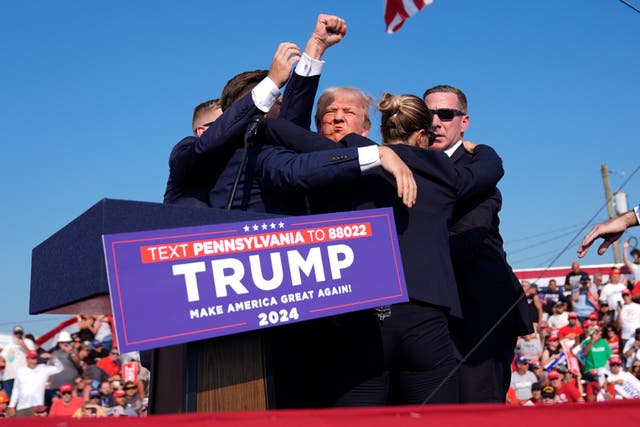<p>Former president Donald Trump raises his fist as Secret Service agents in Butler, PA escort him off the stage. </p>