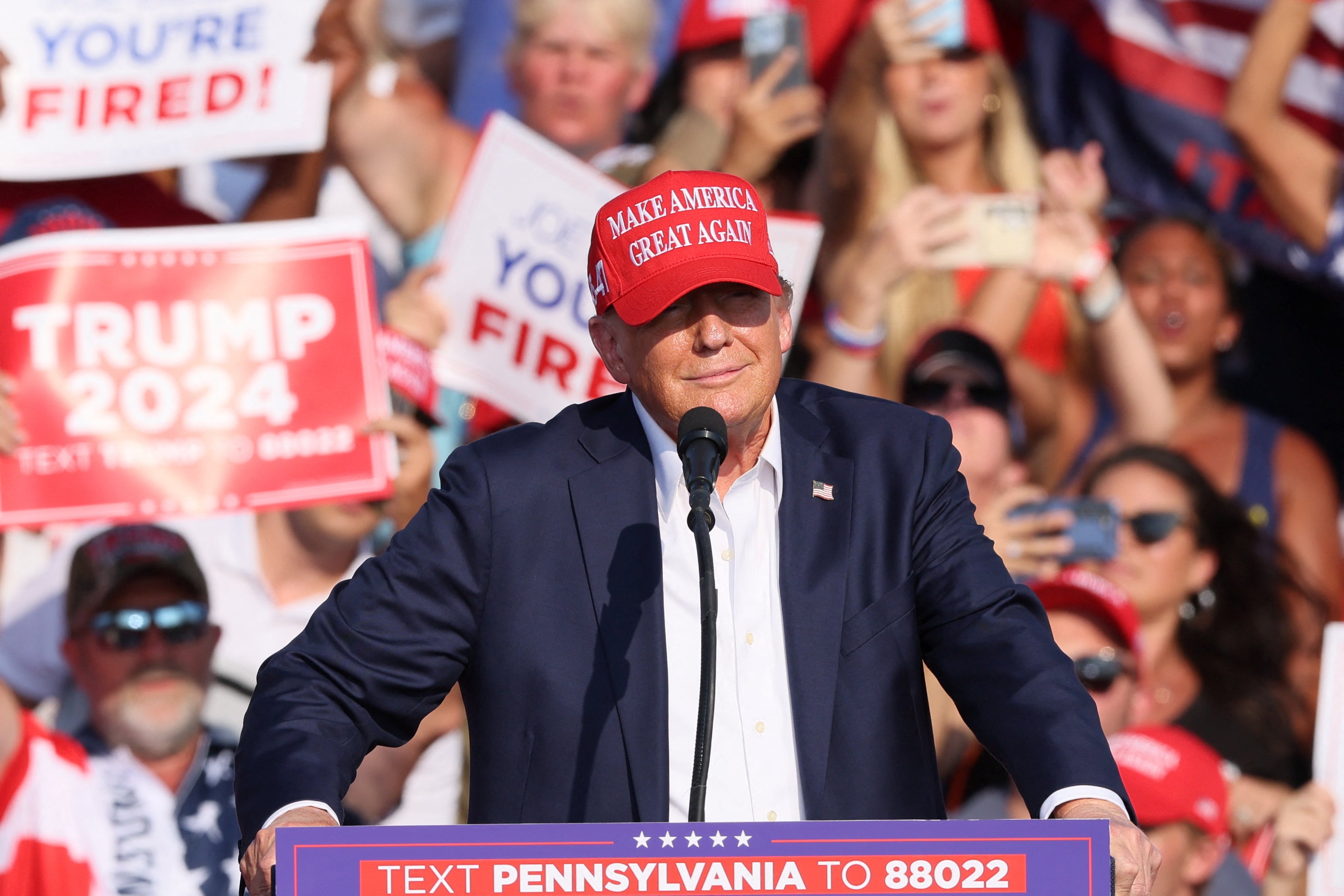 Popping sounds came from the left of where Trump was speaking at a lectern, minutes before he took to the stage