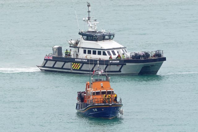 An RNLI lifeboat and a Border Force vessel in the English Channel (Gareth Fuller/PA)