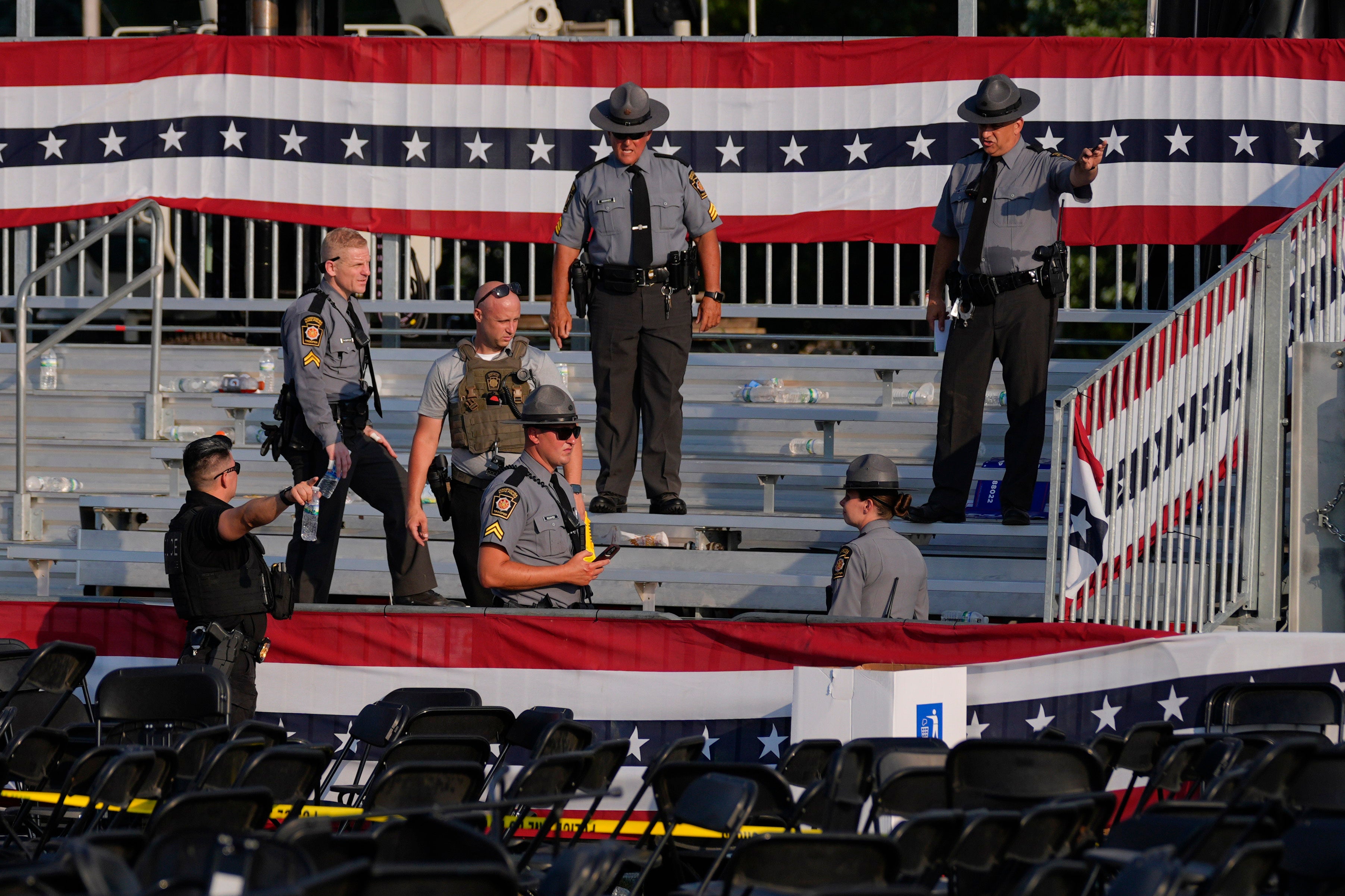 Law enforcement officials gathered in the stands after the crowd filed out and started their investigation