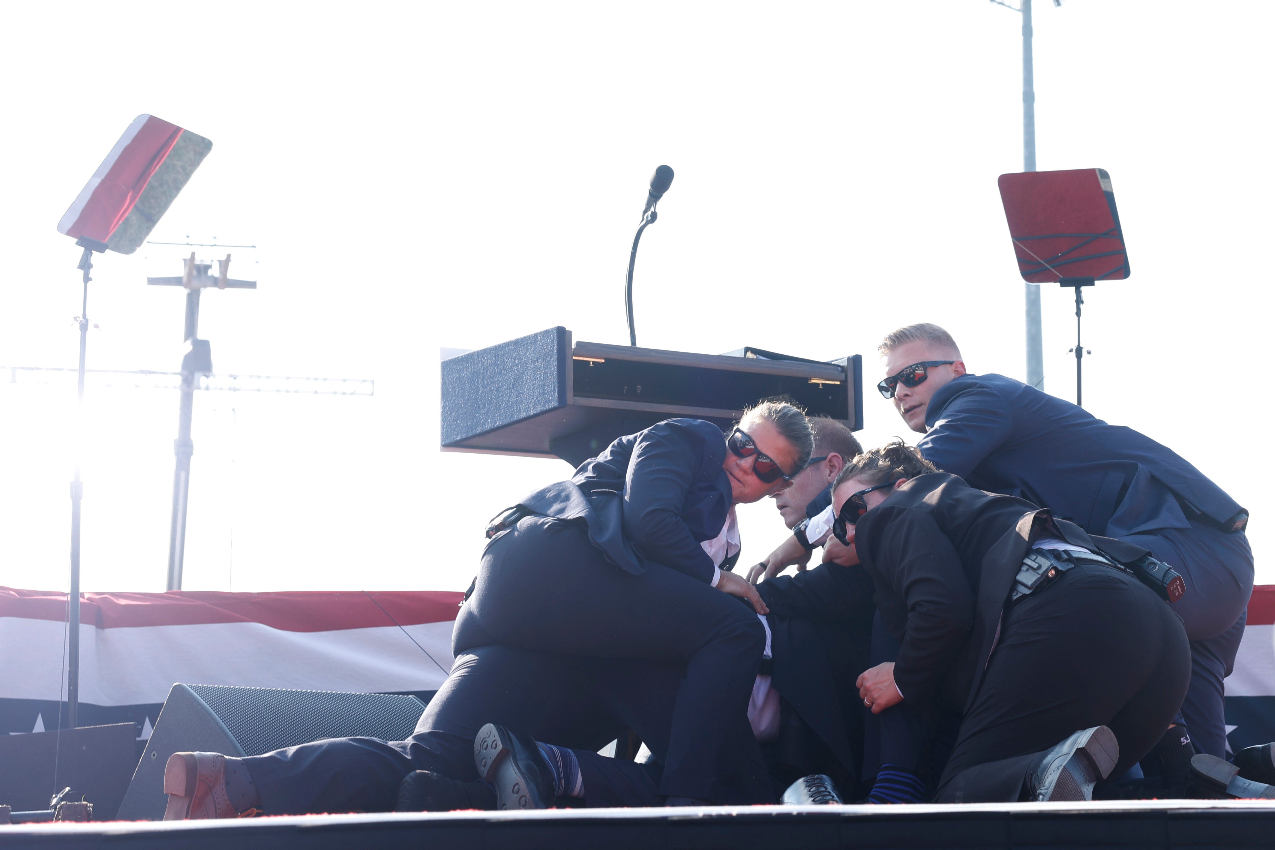 Trump is taken to the floor by his security team during the assassination attempt in Butler, Pennsylvania