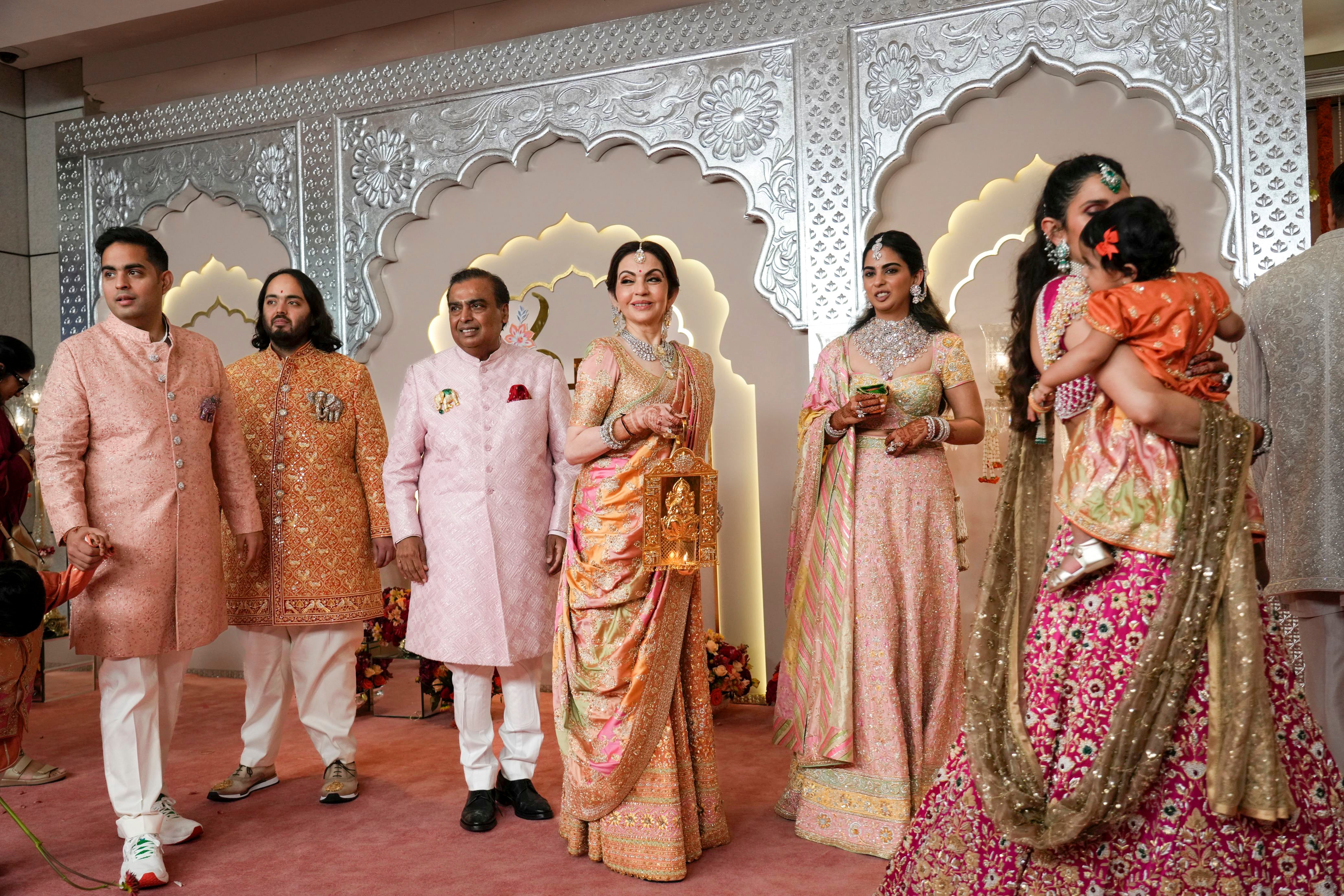 Billionaire Mukesh Ambani, third left, stands with his family members from left to right, son Akash, son Anant, wife Nita, daughter Isha and daughter-in-law Shloka at the wedding of his son Anant Ambani and Radhika Merchant