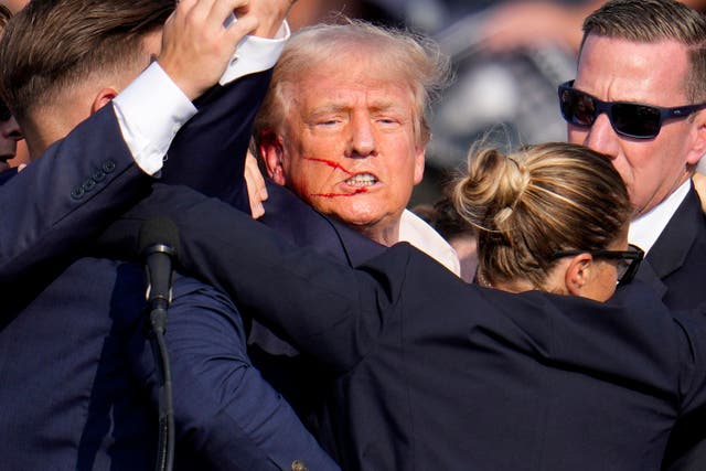 <p>Republican presidential candidate former President Donald Trump is helped off the stage by U.S. Secret Service agents at a campaign event in Butler, Pennsylvania </p>