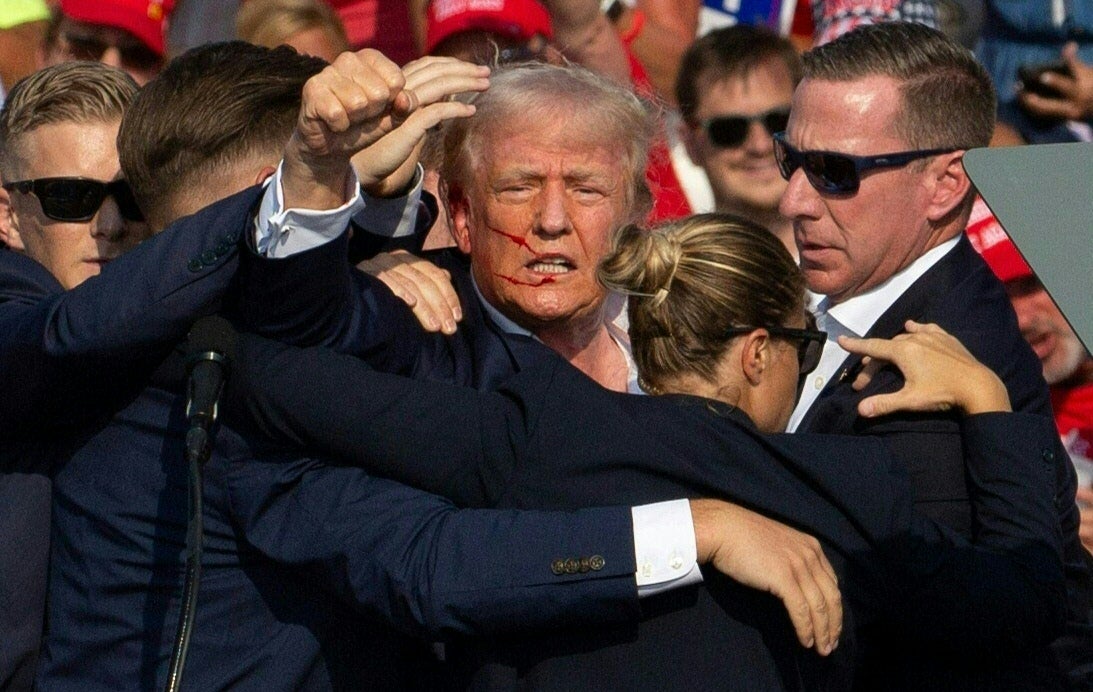 Trump pumps his fist after being struck in the ear by a bullet. The former president has said he is “fine” since the shooting