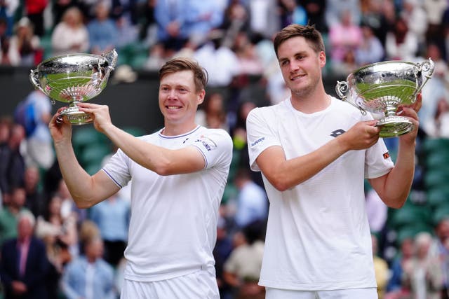 Harri Heliovaara, left and Henry Patten lift the trophies (Mike Egerton/PA)