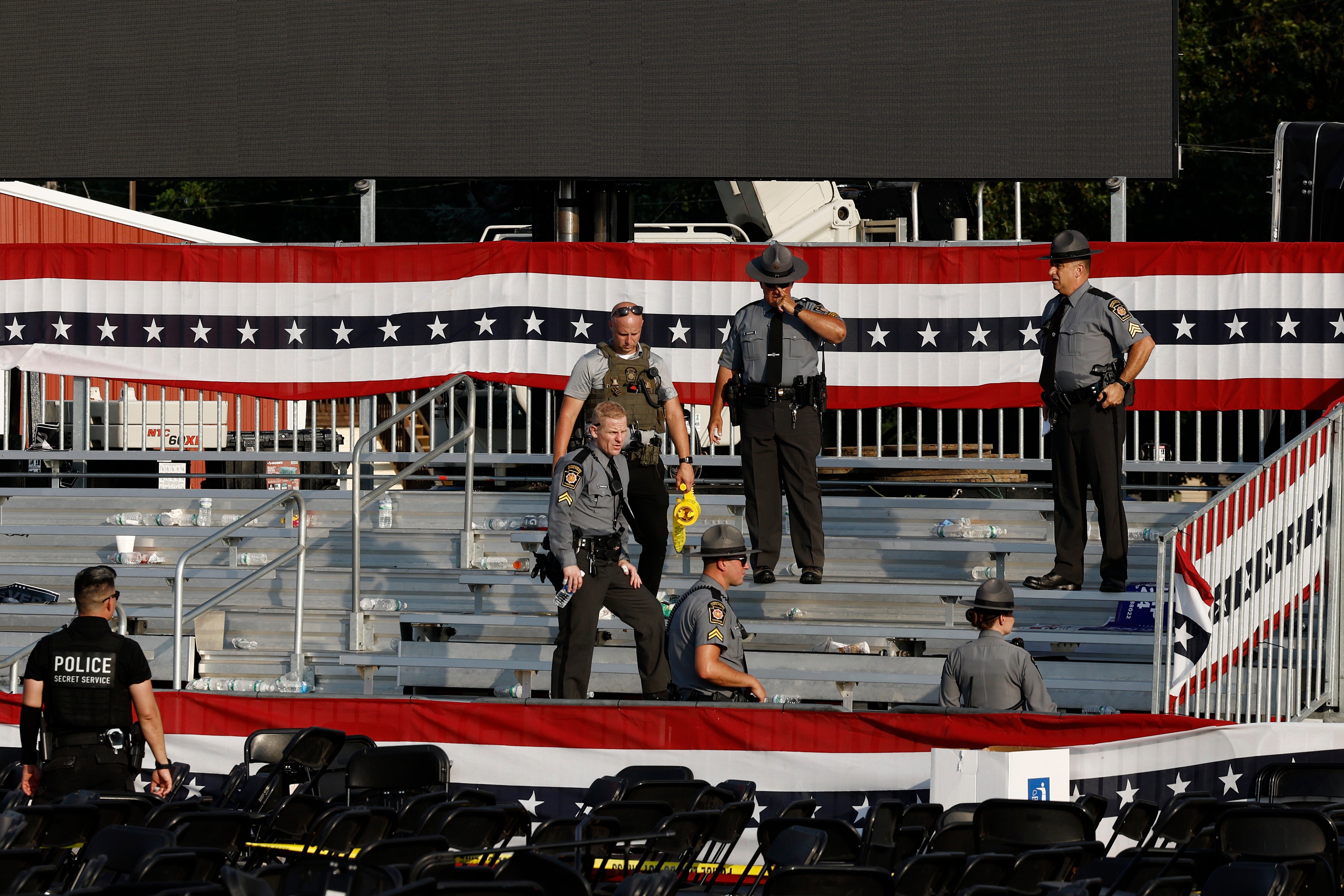 Law enforcement agents stand at the Butler, Pennsylvania rally site where Thomas Matthew Crooks opened fire, injuring two attendees and killing one