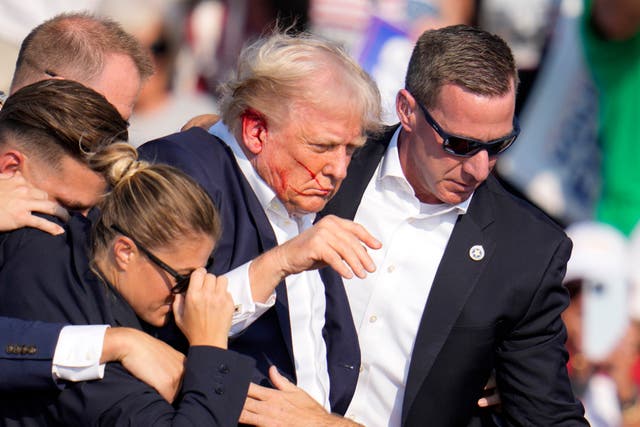 <p>Donald Trump was helped off the stage after an assassination attempt in Butler, Pennsylvania on Saturday July 13, 2024 </p>