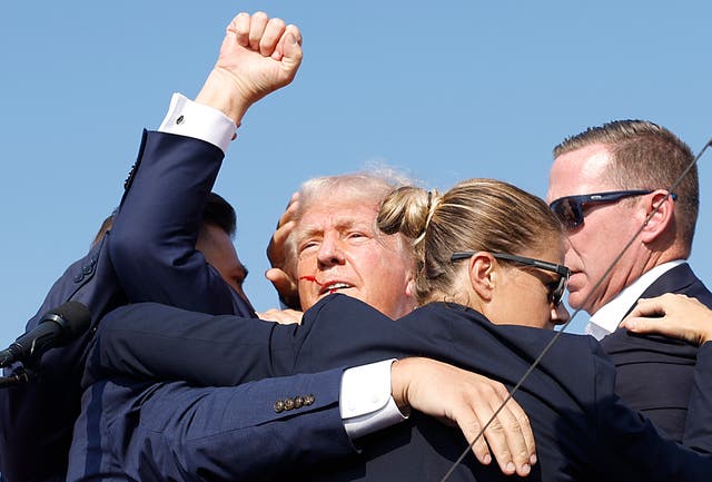 <p>Secret Service agents rush Donald Trump off a rally stage after he survived an assassination attempt on July 13. The agency has rejected false claims that his campaign was denied additional protections. </p>