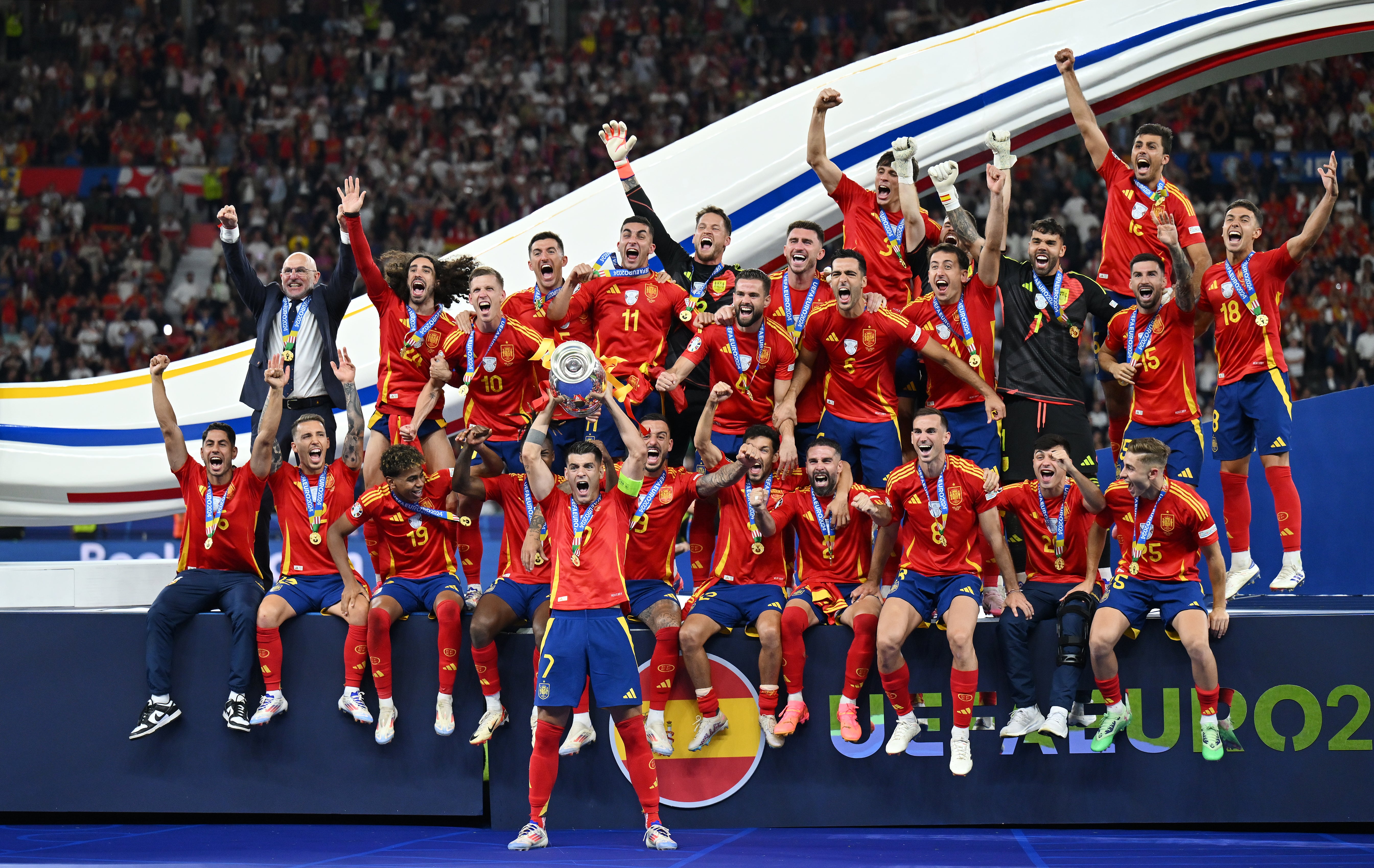 Alvaro Morata hoists the European Championship trophy aloft