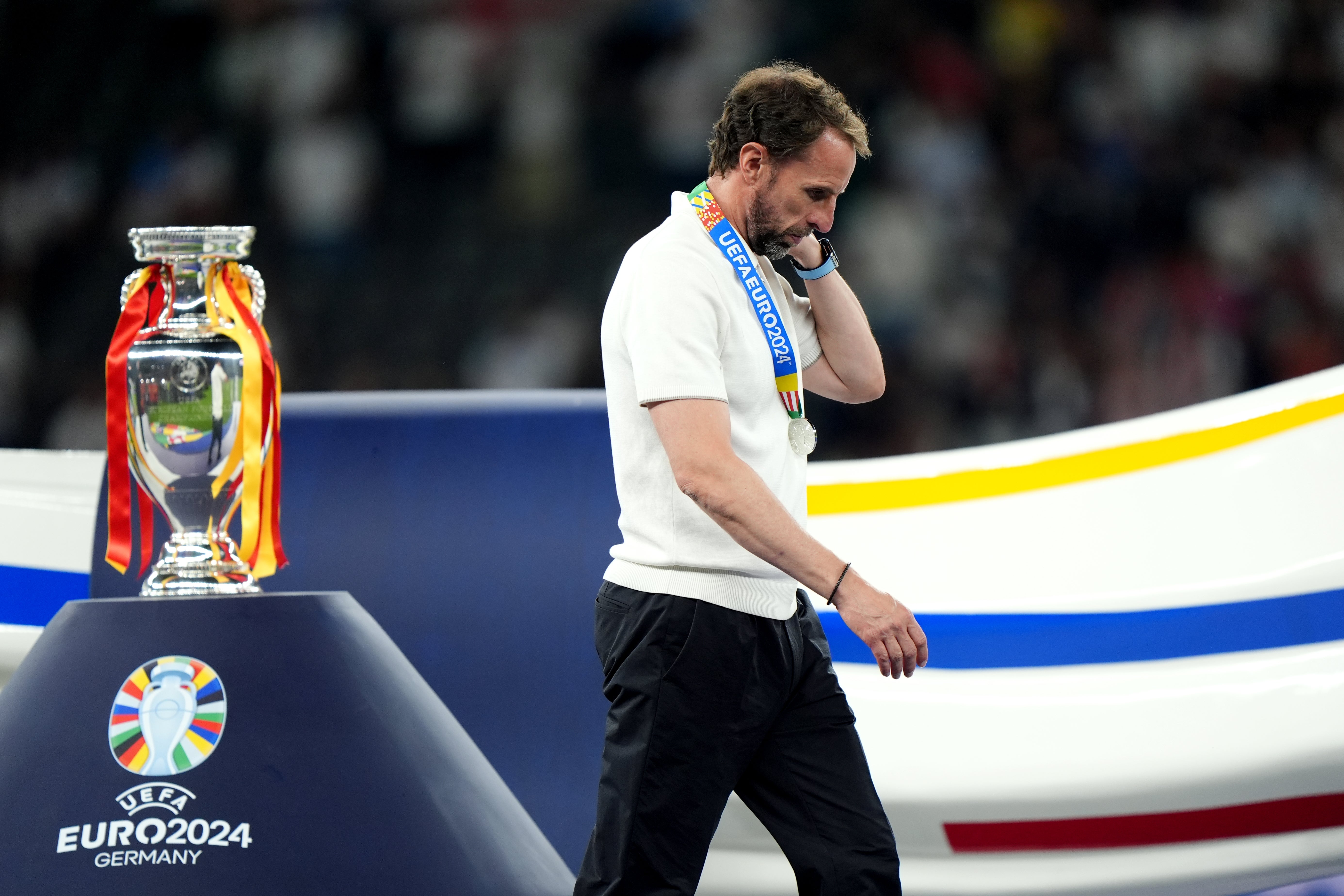 Gareth Southgate walks dejected past the Euro 2024 trophy (Bradley Collyer/PA)