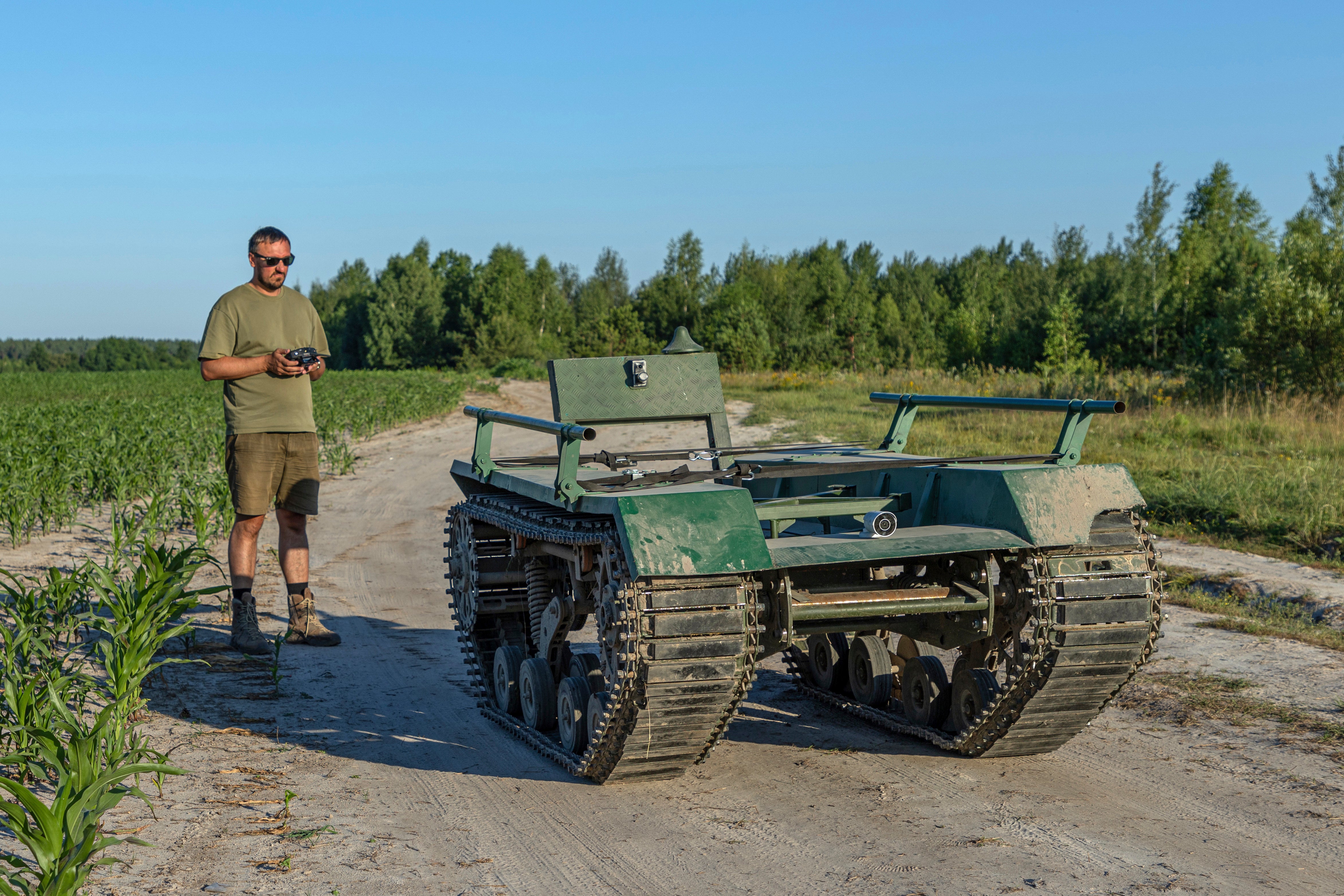 Andrii Denysenko, CEO of design and production bureau “UkrPrototyp”, stands by Odyssey, an 800-kilogram (1,750-pound) ground drone prototype, at a corn field in northern Ukraine, Friday, June 28, 2024