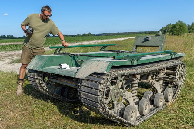 <p>Andrii Denysenko, CEO of design and production bureau "UkrPrototyp", stands by Odyssey, an 800-kilogram (1,750-pound) ground drone prototype, at a corn field in northern Ukraine, Friday, June 28, 2024</p>