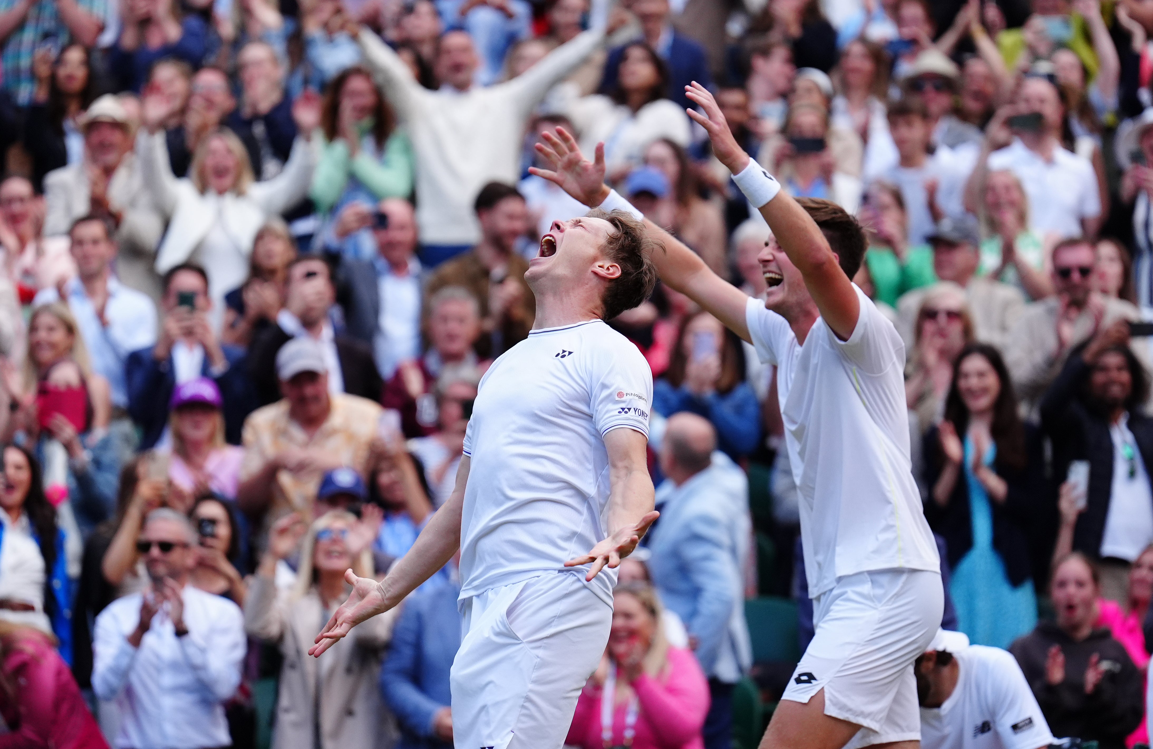 Henry Patten, right, and Harri Heliovaara celebrate their men’s doubles title (Mike Egerton/PA)