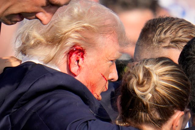 <p>Donald Trump is escorted to a motorcade following the attempted assassination (Gene J. Puskar/AP)</p>