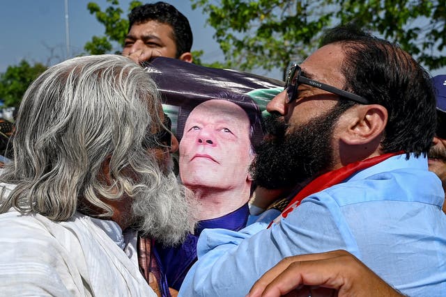 <p>Supporters of Pakistan’s former prime minister Imran Khan with his portrait after a court verdict overturned his illegal marriage conviction</p>
